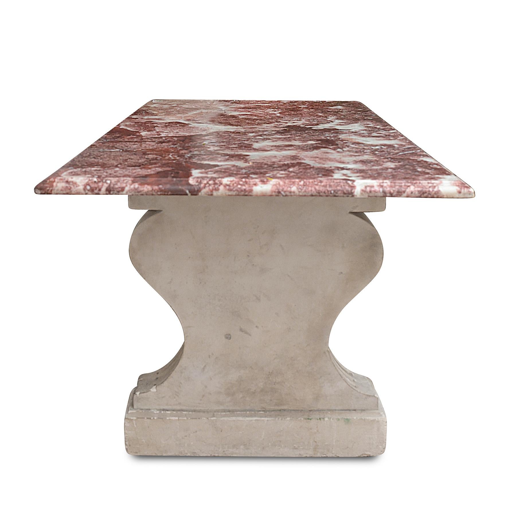 A midcentury, c. 1950, French table with extremely attractive red marble top, with two fluted cast trestle bases.

The lush marble top, a triumphant field of claret red, with vigorous veining, has a thumbnail edge profile

Dimensions: 71.5” x 34” D