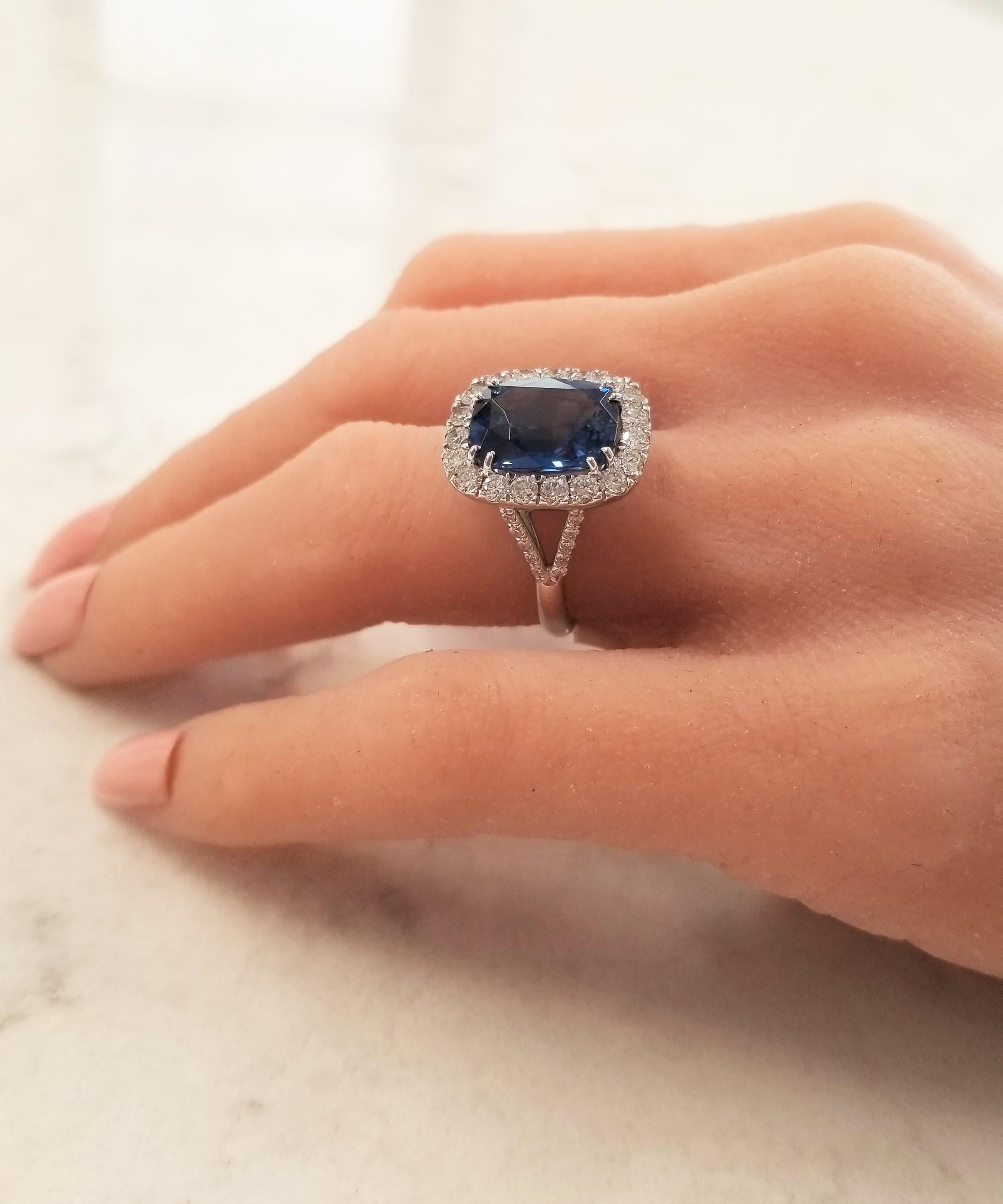 This is a 7.16 carat natural royal blue oval sapphire that measures 12.31 x 9.80mm. The gem source is Sri Lanka; the saturation is what you want with excellent transparency and luster. Large round brilliant cut white diamonds frame this sapphire