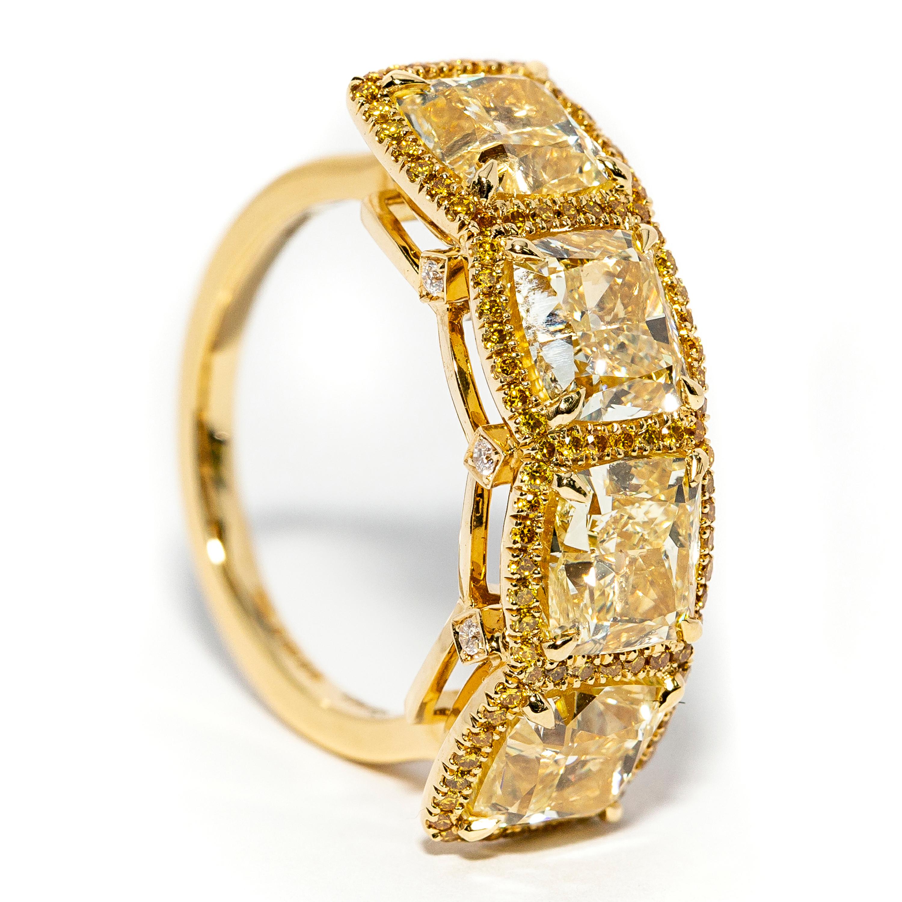 This gorgeous 6.80 Carat Cushion Cut Ring Color Y-Z Clarity VS2 featuring 0.36 Carat of Round Fancy Yellow Diamonds Clarity SI1 set in Halo Design around the larger stones and 3 small white stones on each side of the mount, Adding timeless glamour