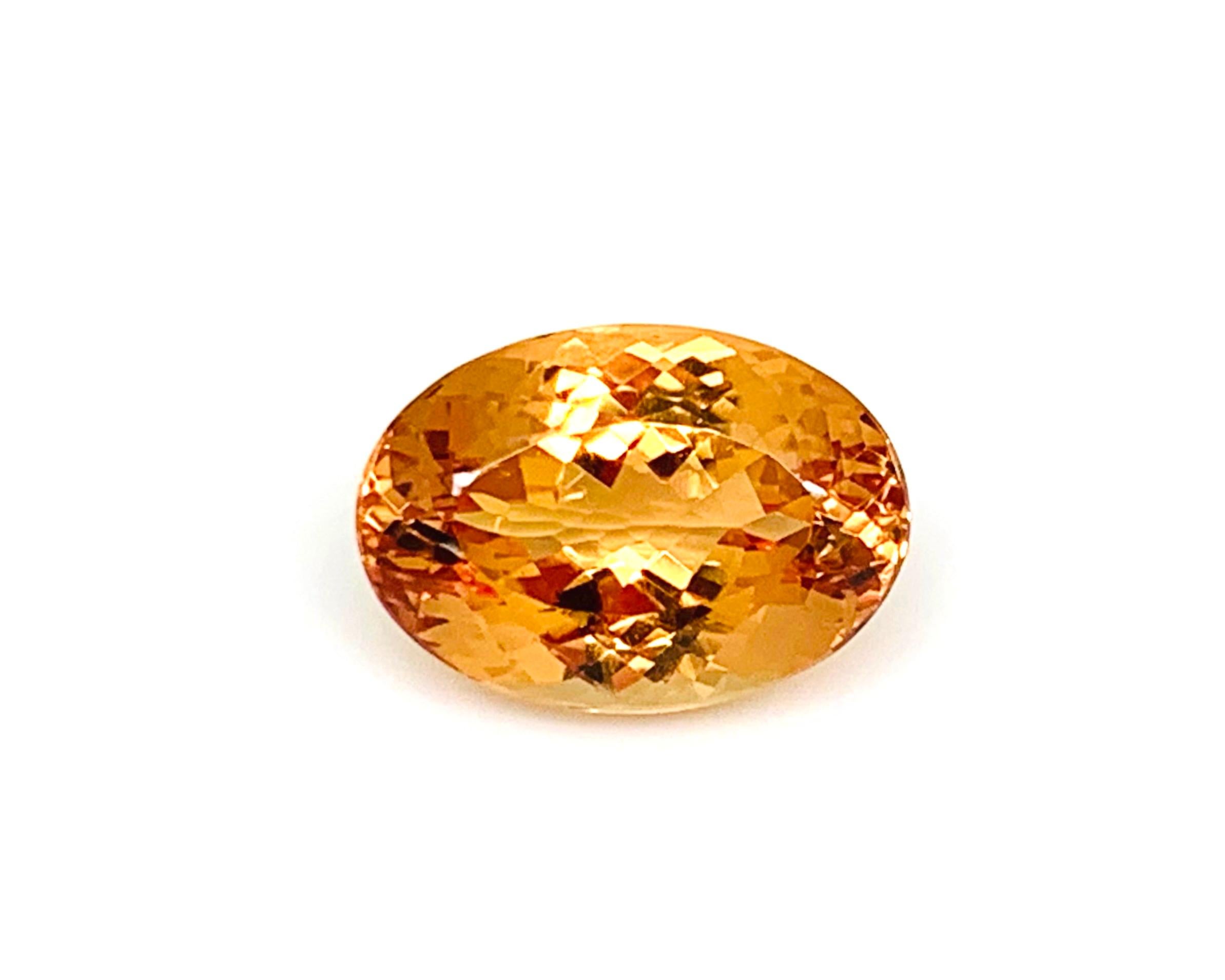 This beautiful 7.16 carat precious topaz has brilliant apricot-orange color and exceptional clarity! Measuring 13.43 x 9.40 x 7.08 millimeters, this beautifully well-proportioned oval is extremely well-cut and a versatile shape that will lend itself