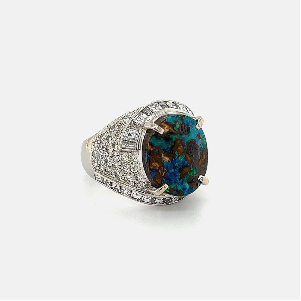Simply Beautiful! Australian Boulder Opal Vintage Solitaire Platinum Cocktail Ring. Centering a securely nestled Hand set 7.18 Carat Australian Boulder Opal. Surrounded by Diamonds, weighing approx. 2.70tcw. Hand crafted in Platinum with great
