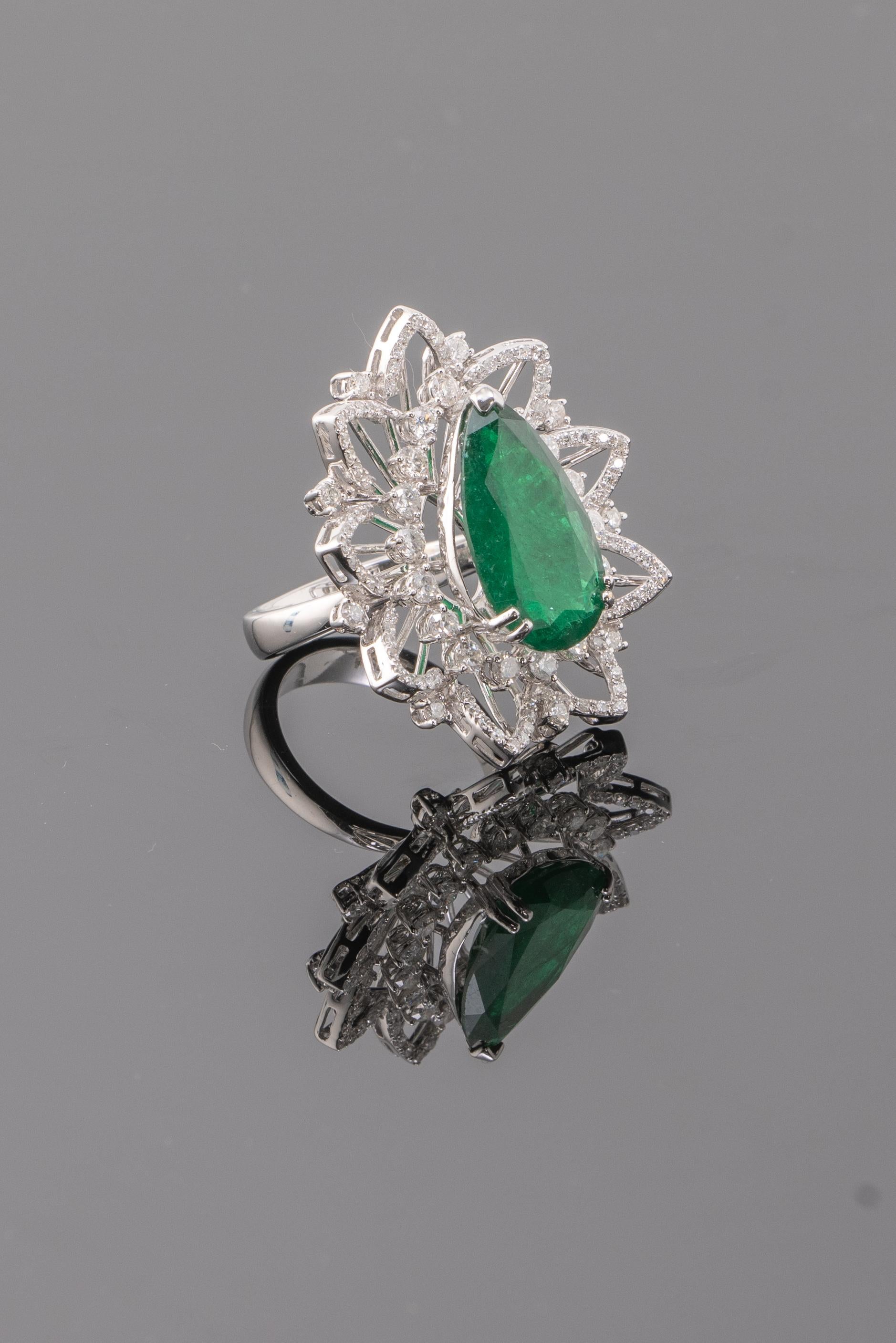 A very unique, 7.18 carat pear shape natural Zambian Emerald and Diamond cocktail ring set in solid 18K White Gold. Currently sized at US 6, can be changed upon request. Please feel free to message us if you have any queries. Free shipping provided.