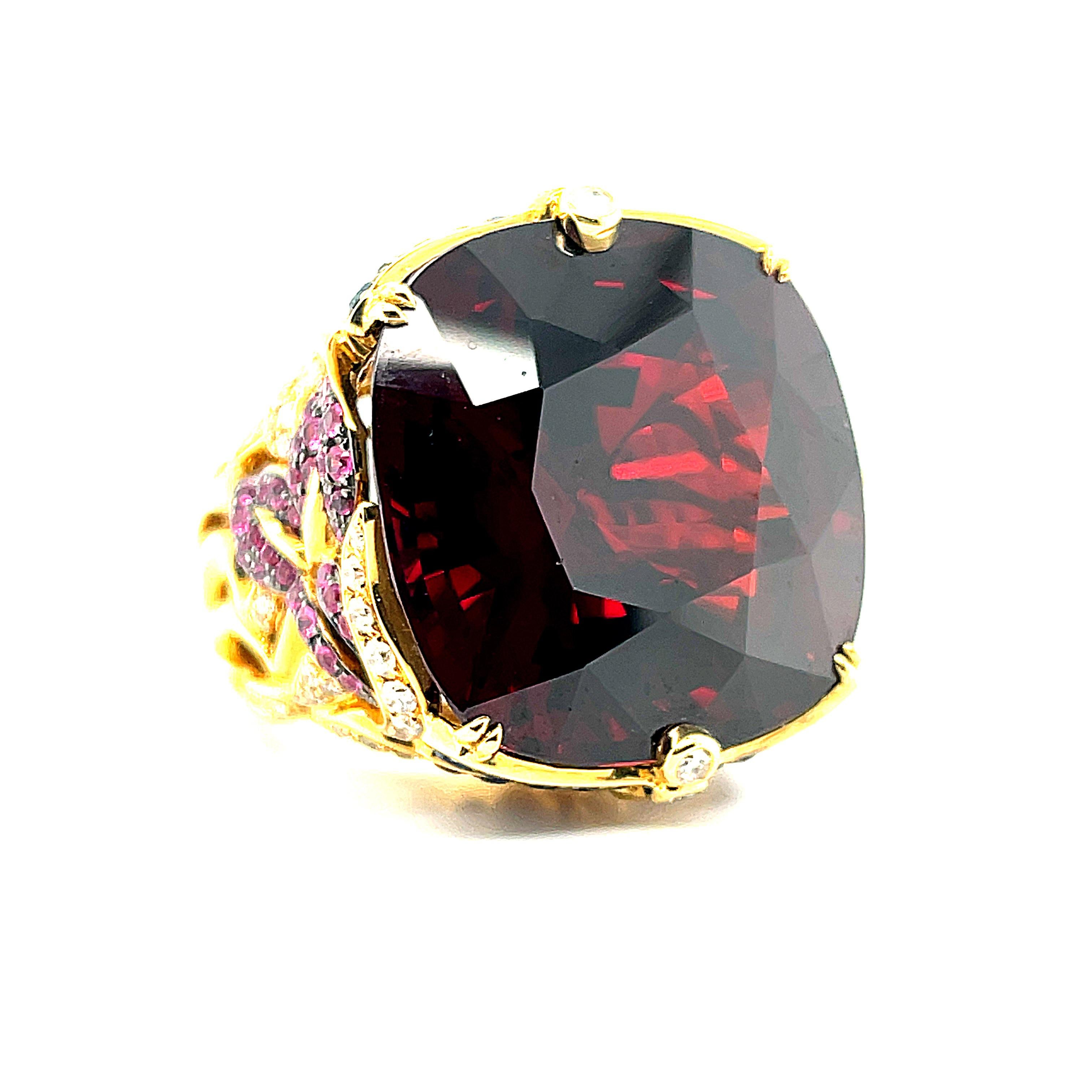 This impressive statement ring is set with an enormous cushion-cut Mozambique red garnet that weighs a whopping 71.87 carats! The garnet is a beautifully crystalline, brilliant gem, with rich, orangy-red color - such unusual and superior quality in