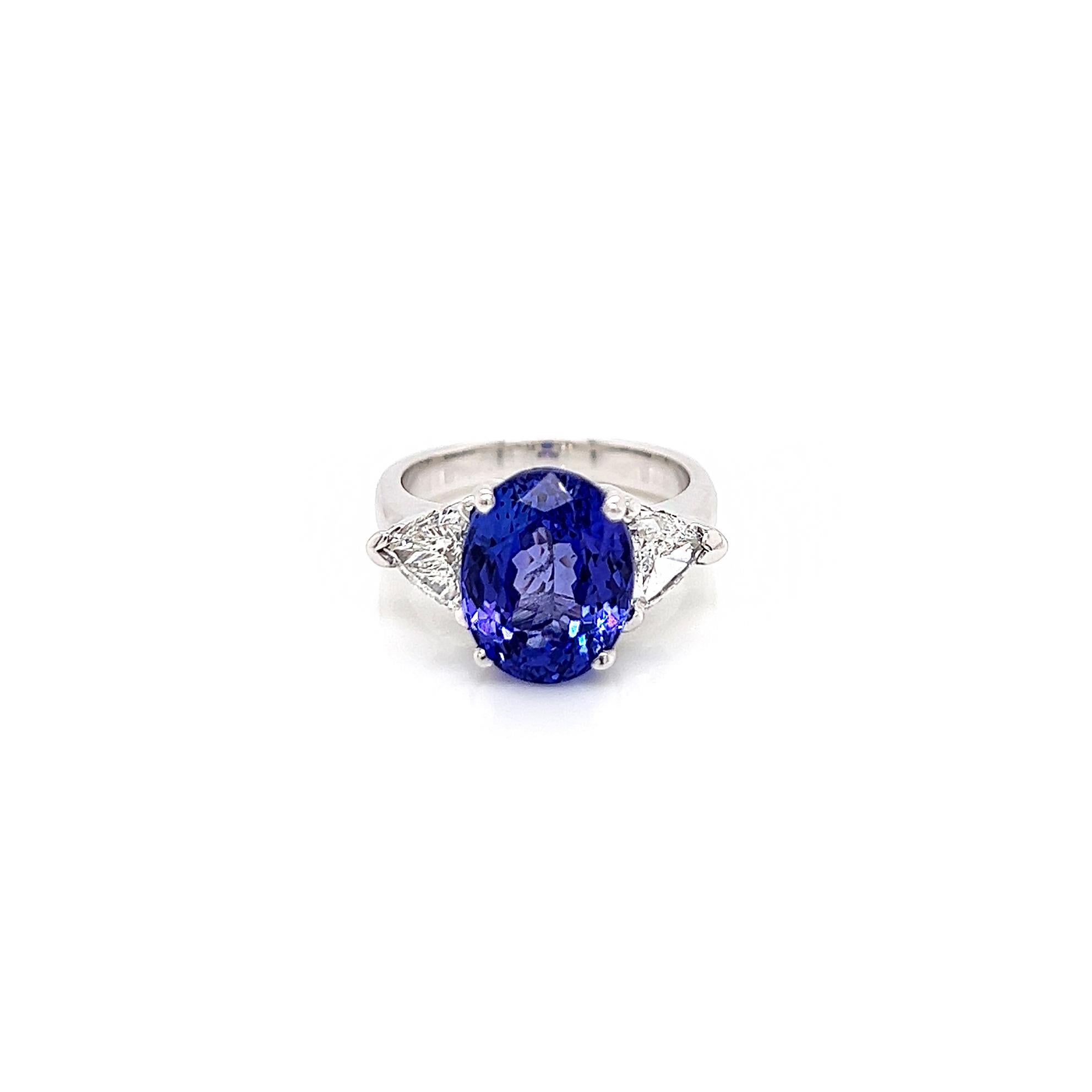 7.18 Total Carat Tanzanite and Diamond Three Stone Ladies Ring

-Metal Type: 14K White Gold
-5.46 Carat Oval Cut Natural AAA Quality Tanzanite 
-1.72 Carat Brilliant Cut Natural side Diamonds. G Color, VS1-VS2 Clarity 

-Size 6.5

Made in New York