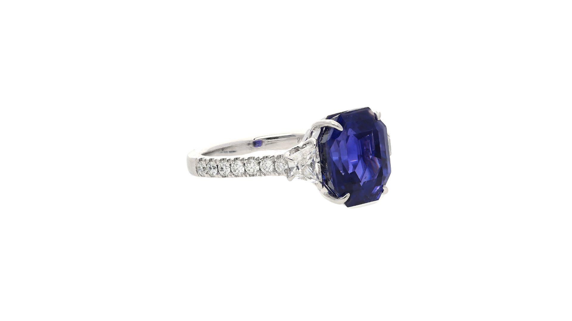 Hailing from the legendary mines of Ceylon, Sri Lanka, a 7.19 carat octagon cut sapphire with a color changing phenomenon. Shifting color from Purplish to Blue in different lights. 

Crafted in 18k white gold, with trapezoid cut diamond side stones