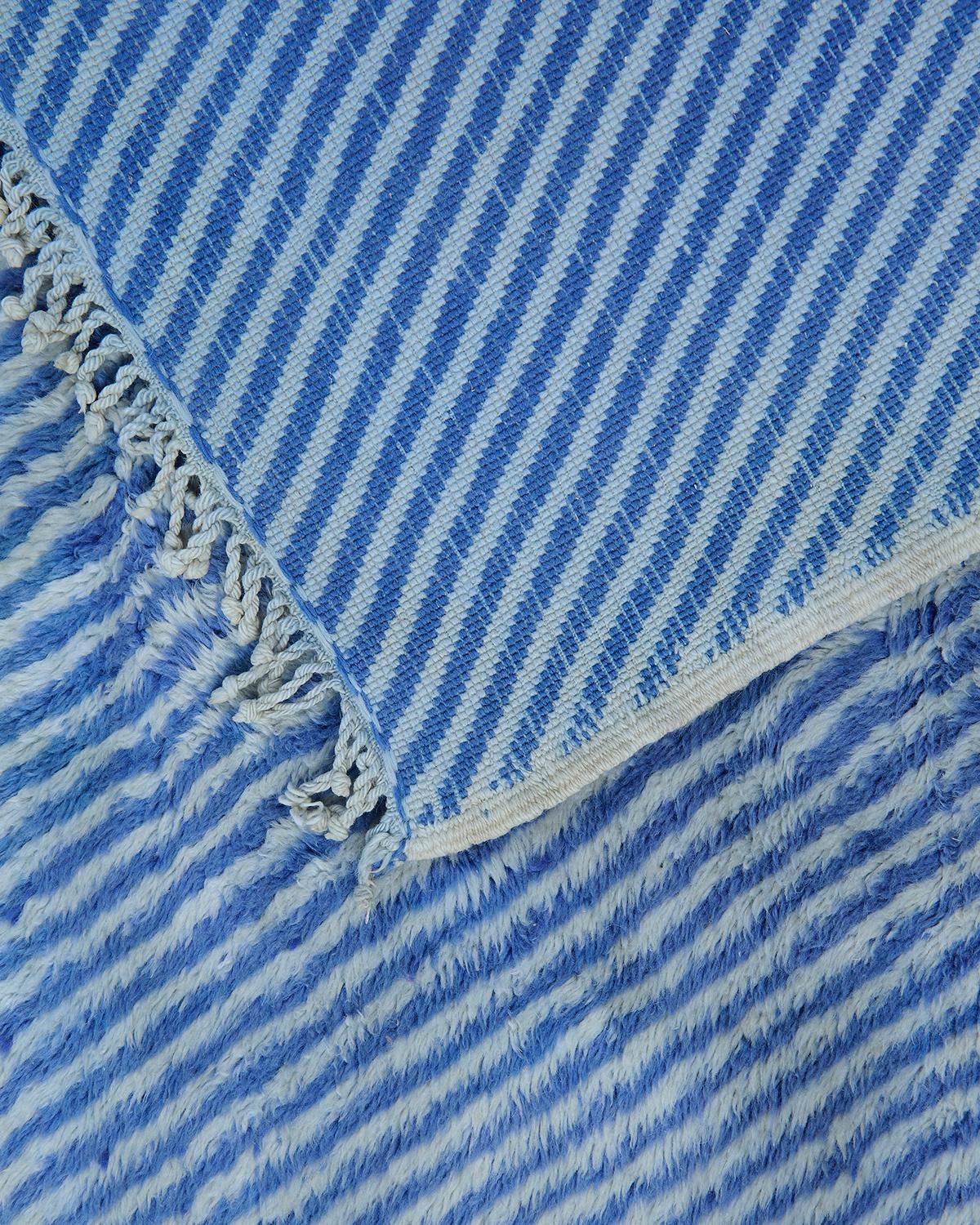 The Marlin rug is a stunning expression of Moroccan textile artistry, handwoven from 100% natural sheep’s wool in the Middle Atlas Mountains. Featuring a crisp blue and white palette, this Beni M’rirt rug blends traditional craftsmanship with a