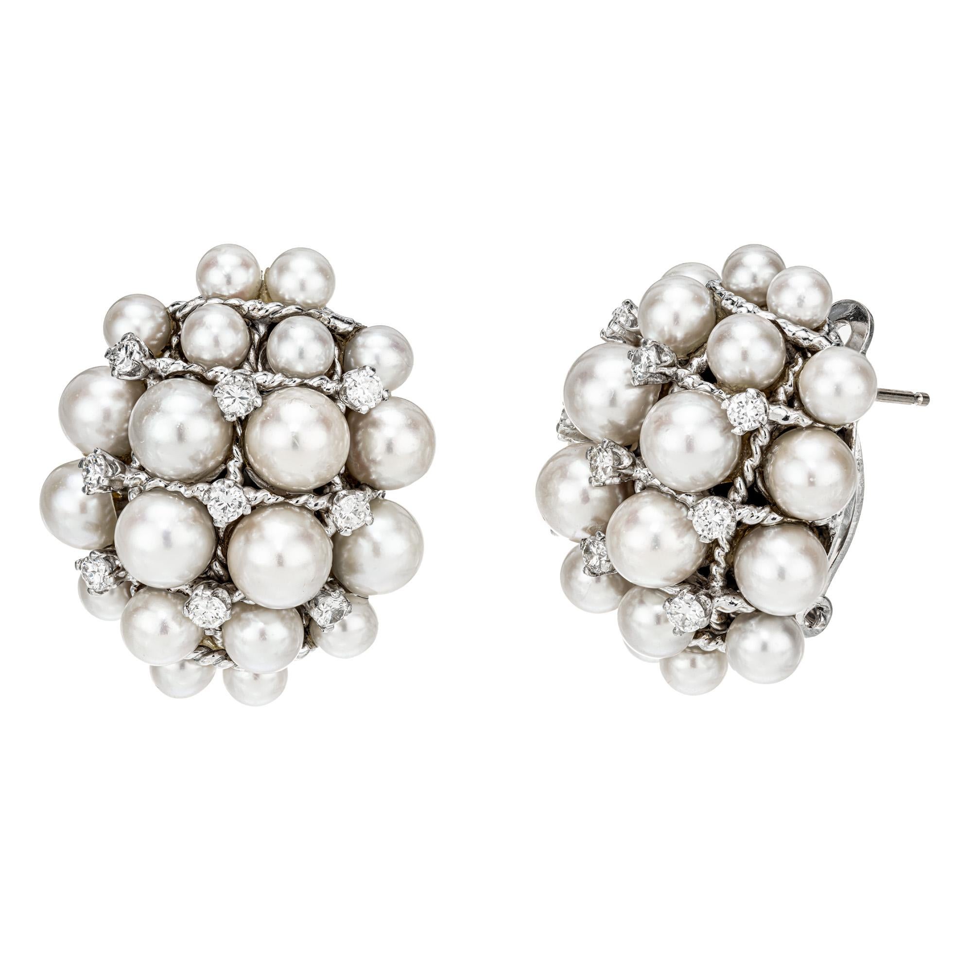 Domed oval 1960's Pearl and diamond cluster clip post earrings. 40 cultured pearls accented with 18 round cut diamonds in 14k white gold clip post earrings. 

40 cultured gray/rose pearls, 3.5mm-5.5mm
18 round diamonds, G-H VS-SI approx. .75cts
14k