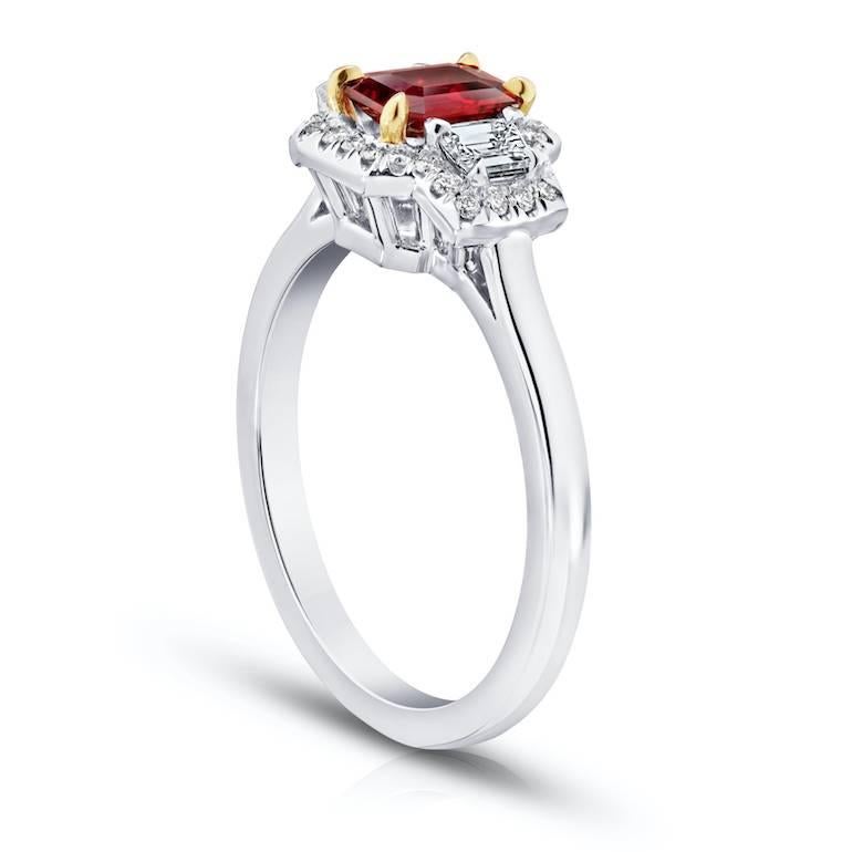 .72 Carat Emerald Cut (natural no heat) Red Ruby with 2 trapezoid cut diamonds .29 carats and 28 brilliant cut diamonds weighing .13 carats set in a platinum with 18k yellow gold ring.
