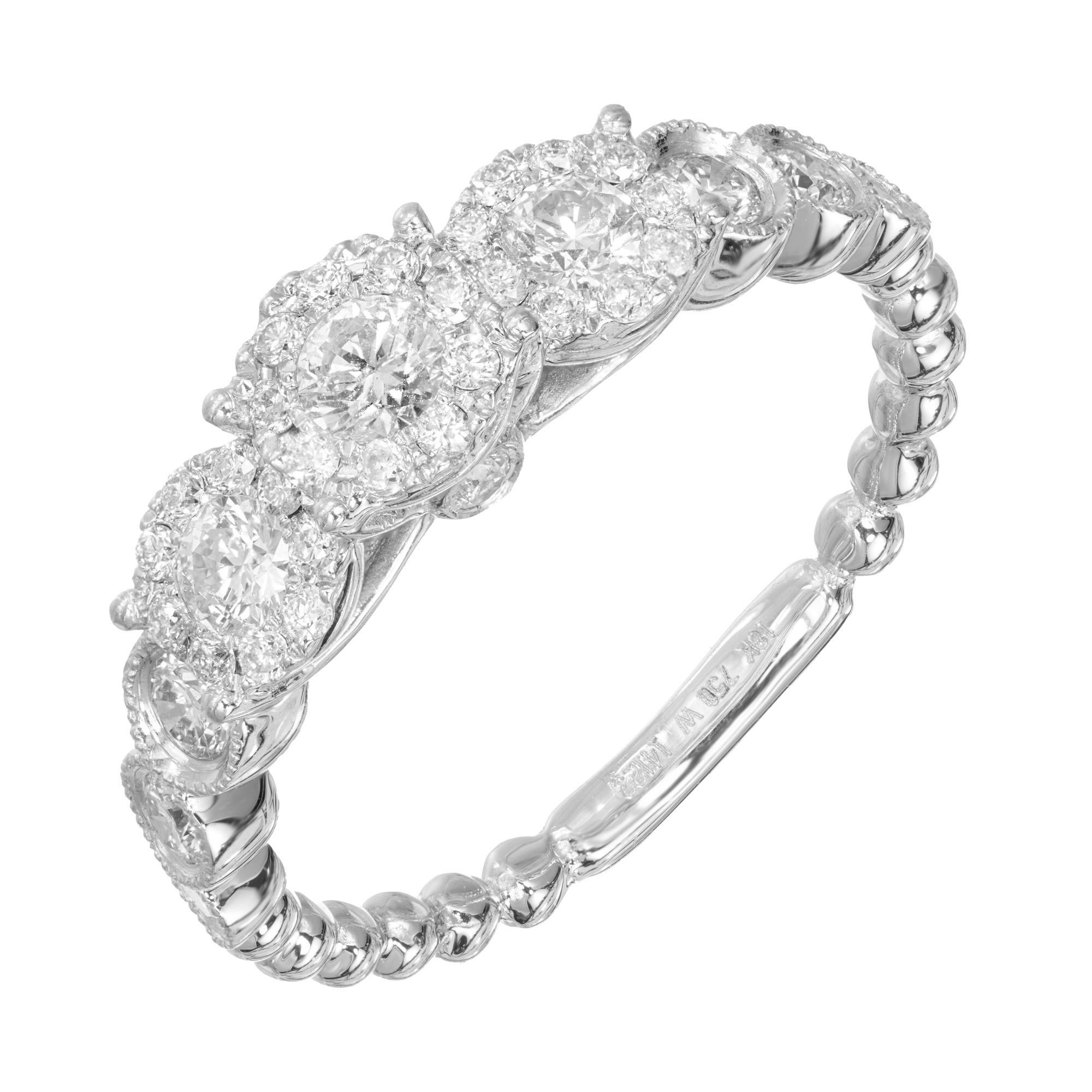Triple Diamond engagement ring. Three center diamonds each with a halo of round cut diamonds set in an 18k white gold setting. A total of 38 round cut sparkly diamonds. 

38 round diamonds, approx. total weight .72cts, H, SI
Size 7 and sizable
18k