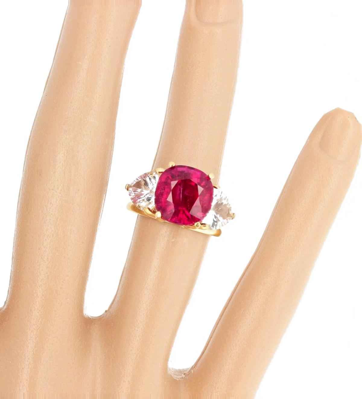 Brilliant 7.2 carat red cushion cut Tourmaline enhanced with trillion cut silvery Topaz set in a unique handmade 18 Kt yellow gold ring size 7 (sizable). PLEASE NOTE:  there is an eye visible inclusion that flashes in the Tourmaline if you turn it