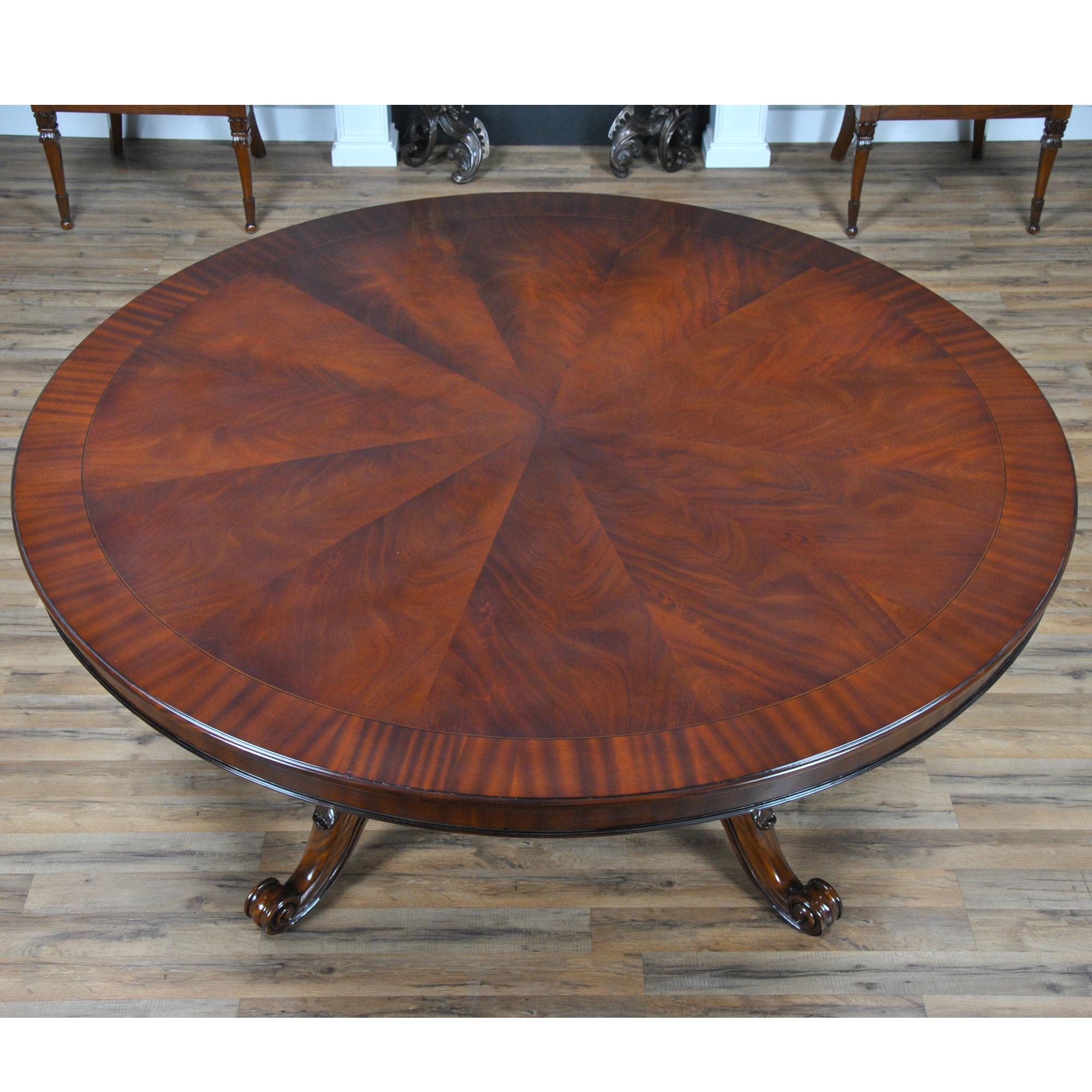 This 72 inch Round Table is as pretty as they come. A fantastic base with scrolled and hand carved feet executed in solid mahogany connects through the platform to carved and turned pillars which are as pretty as the table top. Finished in warm,