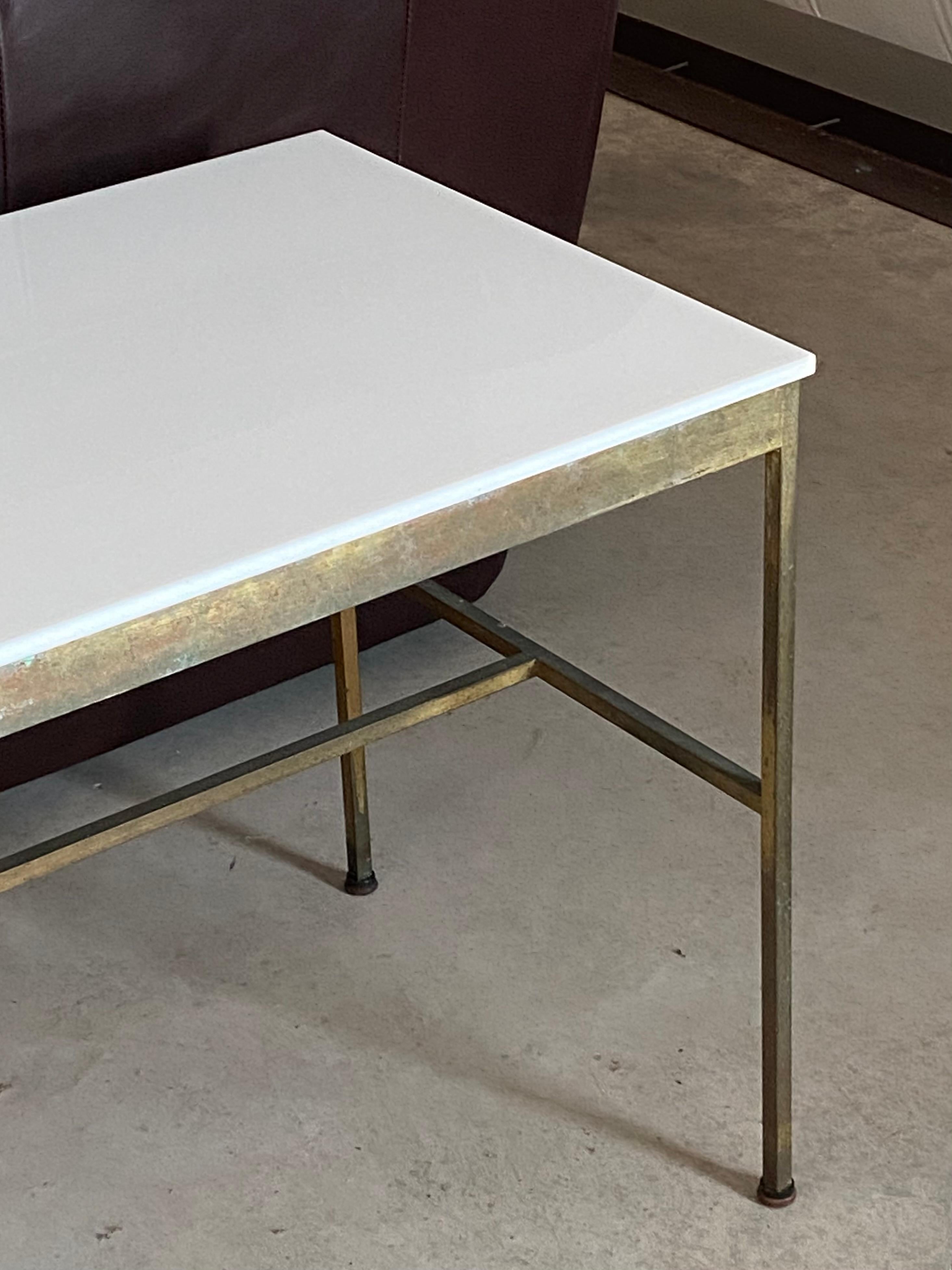 Iconic Paul McCobb brass and Vitrolite console table. Perfect age and oxidation to brass in the coveted longer six foot length. 

A rare example of Mr. McCobb's elegant, streamlined, Minimalist design aesthetic, this console table features an