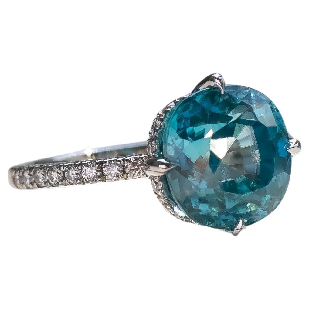 Stunning natural blue Zircon and diamond ring in platinum.

The 7.20ct Zircon is set with east-west prongs, a hidden diamond halo and a diamond band half way around the ring. 

The ring width is 1.6mm, making the ring delicate with the Zircon being