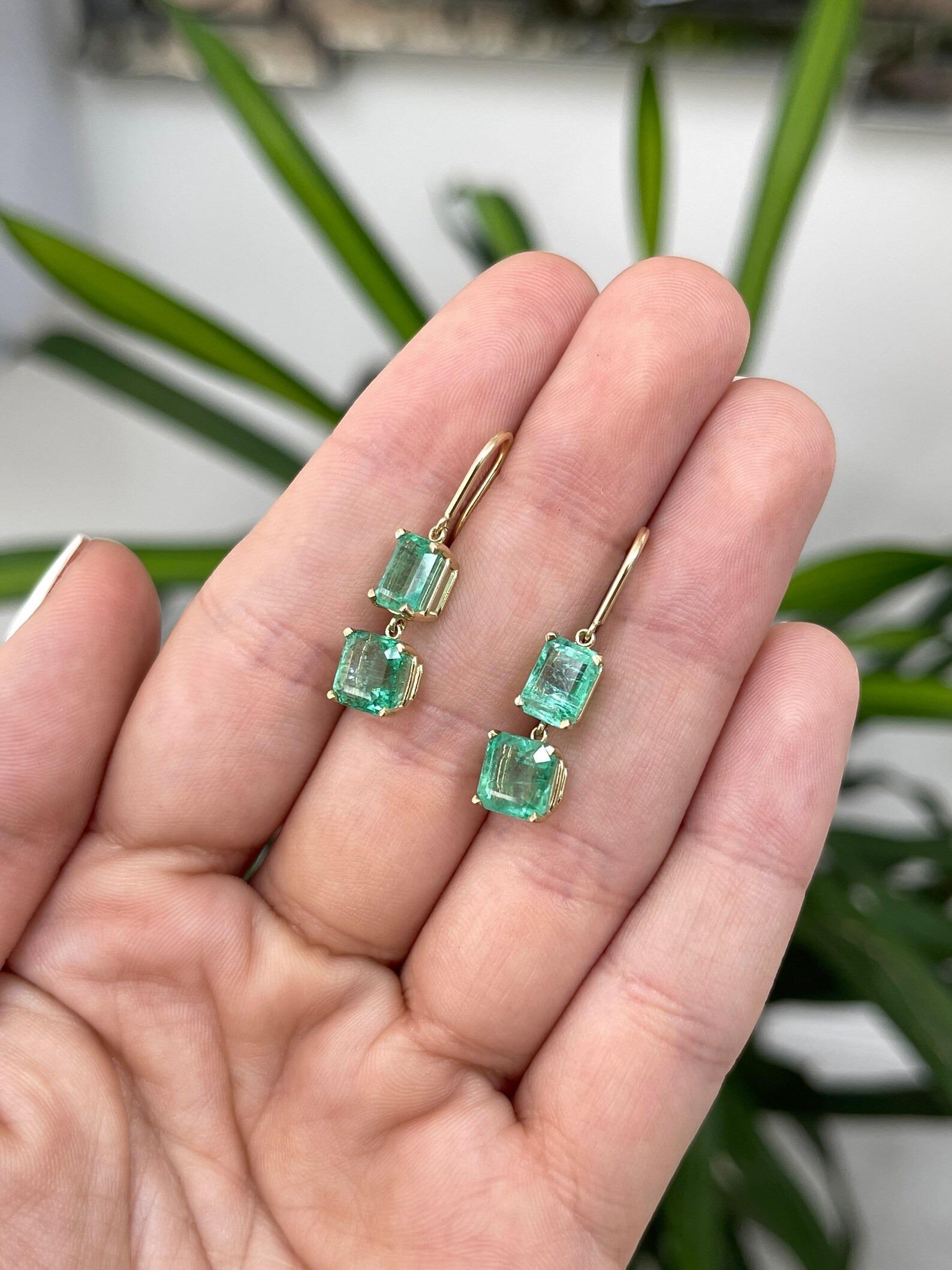 A beautiful pair of natural emerald dangle hook wire gold earrings in 14K. This interesting pair showcases two stunning natural asscher cut emeralds and two striking emerald cut emeralds. The earth-mined gemstones display a rare rich spring green