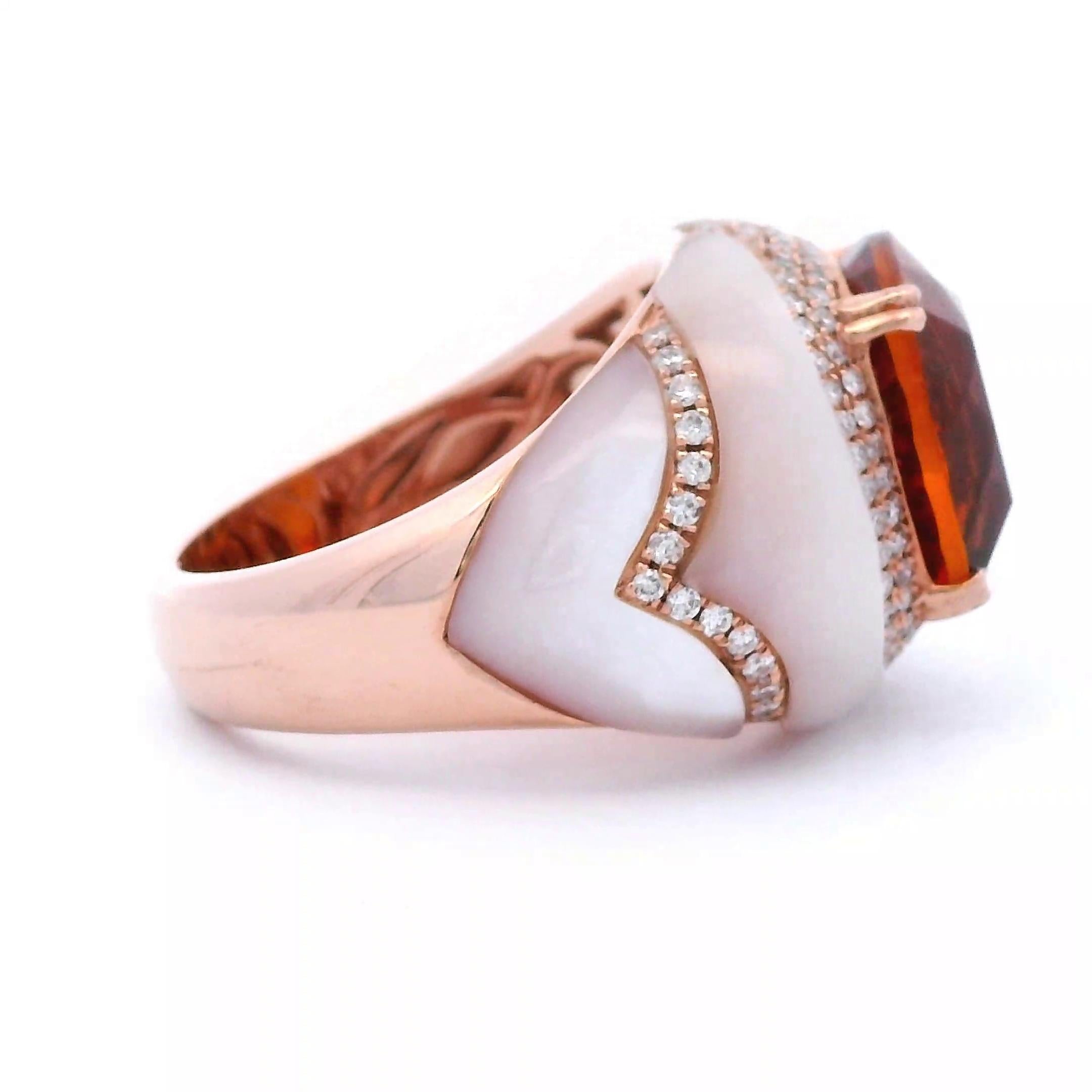 Stunning orange citrine with mother of pearl and diamond ring.
11.74 carats total gemstone weight.
7.21 carat cushion citrine. 4 carved mother-of-pearls, 4.09 carats. 122 round brilliant diamonds, 0.44 carats. Approximately G color and VS2 clarity.
