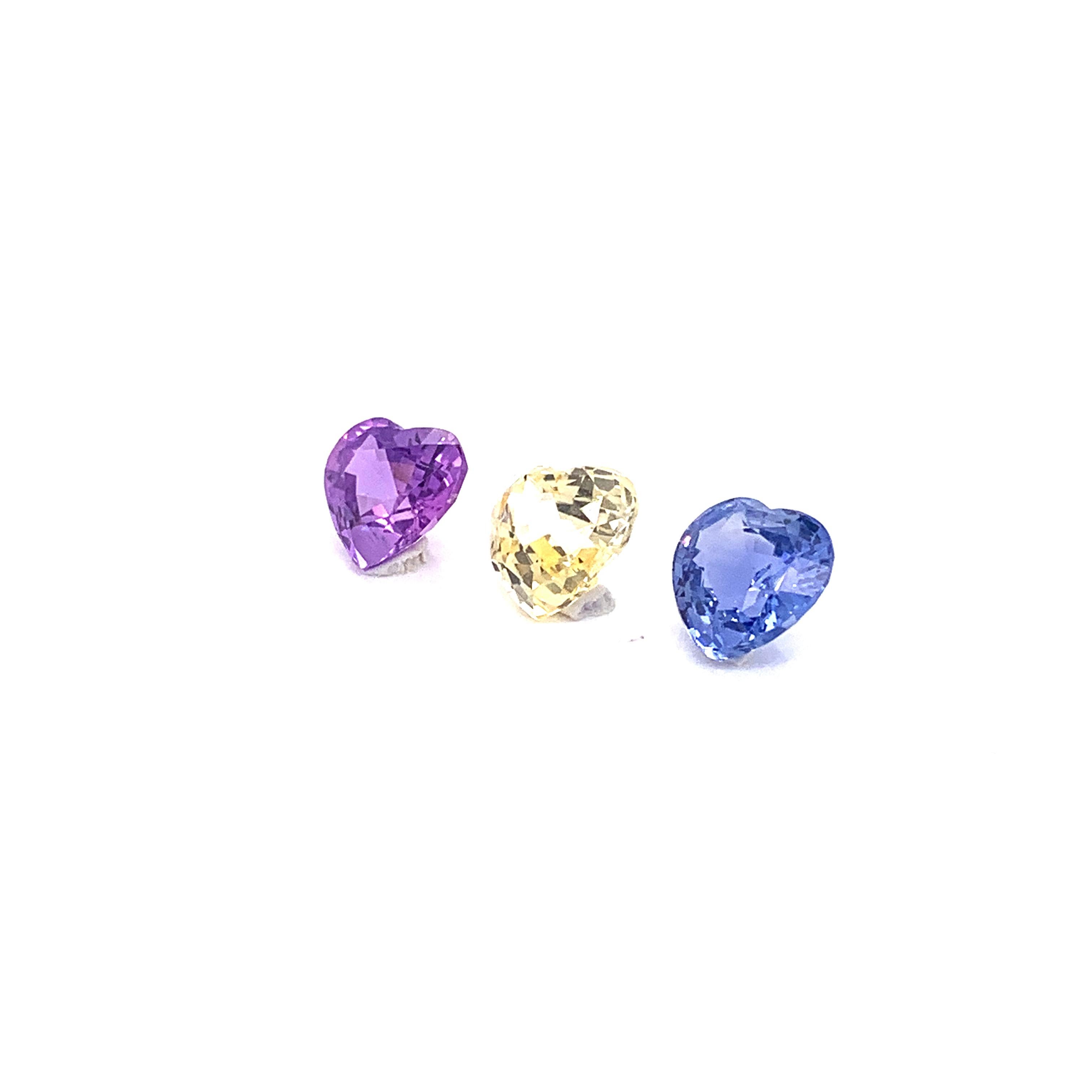 7.22 Carat Heart-Shaped Unheated Blue, Pink, and Yellow Sapphire Trio:

A scintillating trio, it features three natural unheated yellow, pink, and blue sapphires weighing a total of 7.22 carat. The sapphires are unheated, and have excellent cutting
