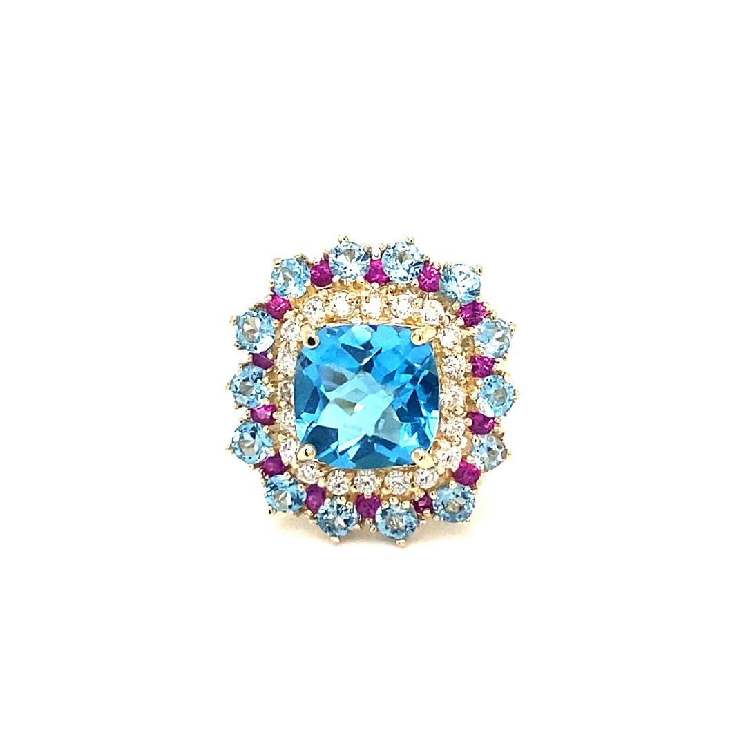 7.23 Carat Blue Topaz Sapphire Diamond Yellow Gold Cocktail Ring

Beautiful to say the Least! 

This Ring has a magnificent Cushion Cut Blue Topaz that weighs 4.73 Carats and is surrounded by 14 Blue Topaz that weigh 1.58 Carats, 14 Pink Sapphires