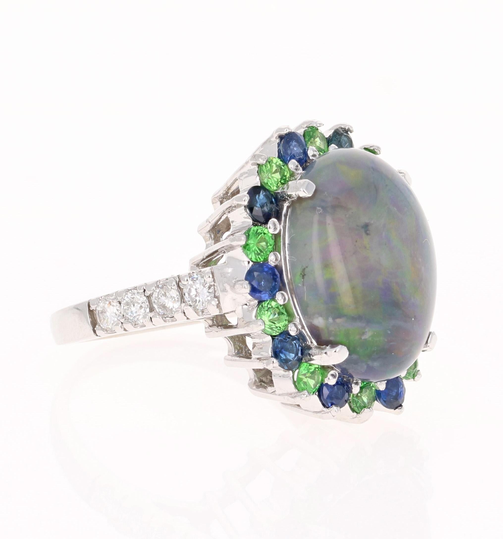 This gorgeou cocktail ring has a large & beautiful Oval Cut Australian Opal that weighs 5.49 Carats. The color of the Opal is a stunning blueish green and is very rare and precious. The ring also has 10 Round Cut Tsavorites that weigh 0.58 Carats