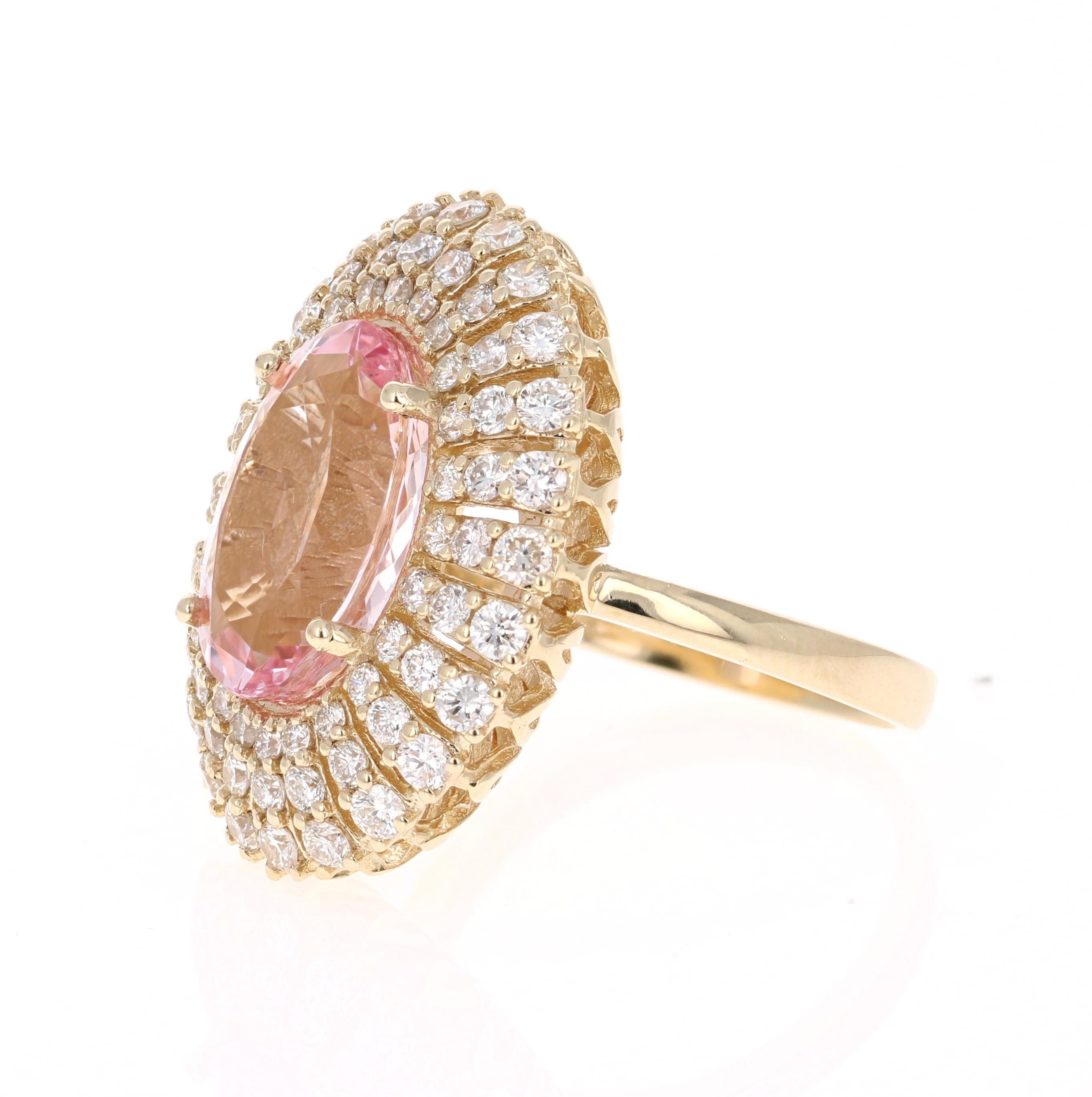 This gorgeous and classy Morganite Cocktail ring has a 5.50 Carat Oval Cut Pink Morganite and has 72 Round Cut Diamonds that weigh 1.74 Carats. The total carat weight of the ring is 7.24 Carats.  

It is set in 14K Yellow Gold and weighs