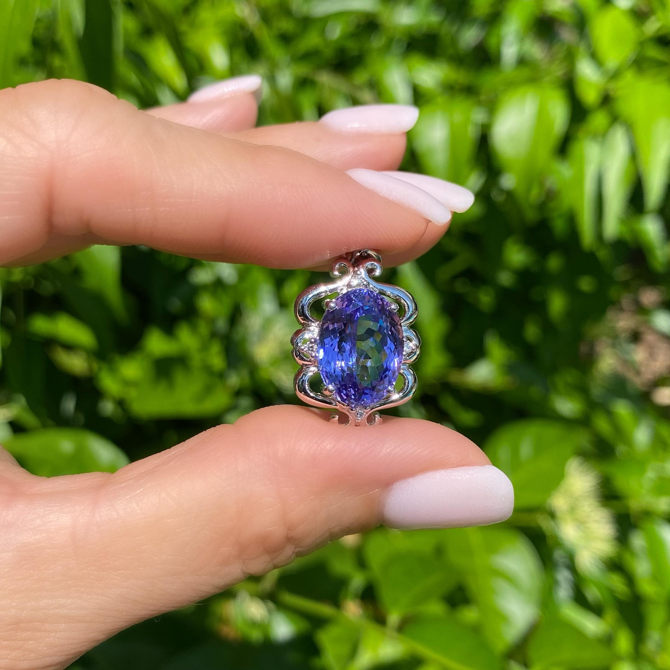 Awesome Tanzanite and Diamond Gold Pendant. Centering a Hand set oval Tanzanite, accented with round Brilliant cut Diamonds approx. 0.05tcw. Hand crafted 18K White Gold mounting. Dimensions: 1.15” l x 0.63” w x 0.28” h. Simply Beautiful! This