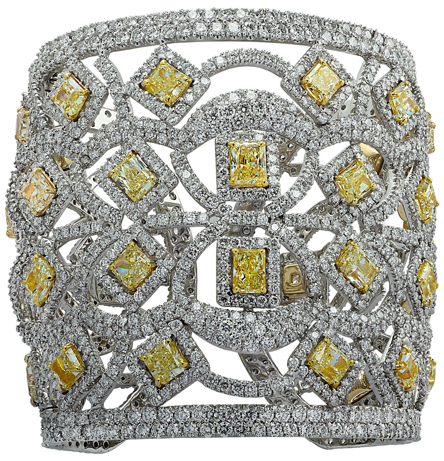 Spectacular Diamond cuff bangle crafted in 18 karat white and yellow gold, showcasing fancy yellow radiant cut and round brilliant cut diamonds weighing approximately 72.44 carats total. 32 Light yellow Radiant cut diamonds weighing approximately
