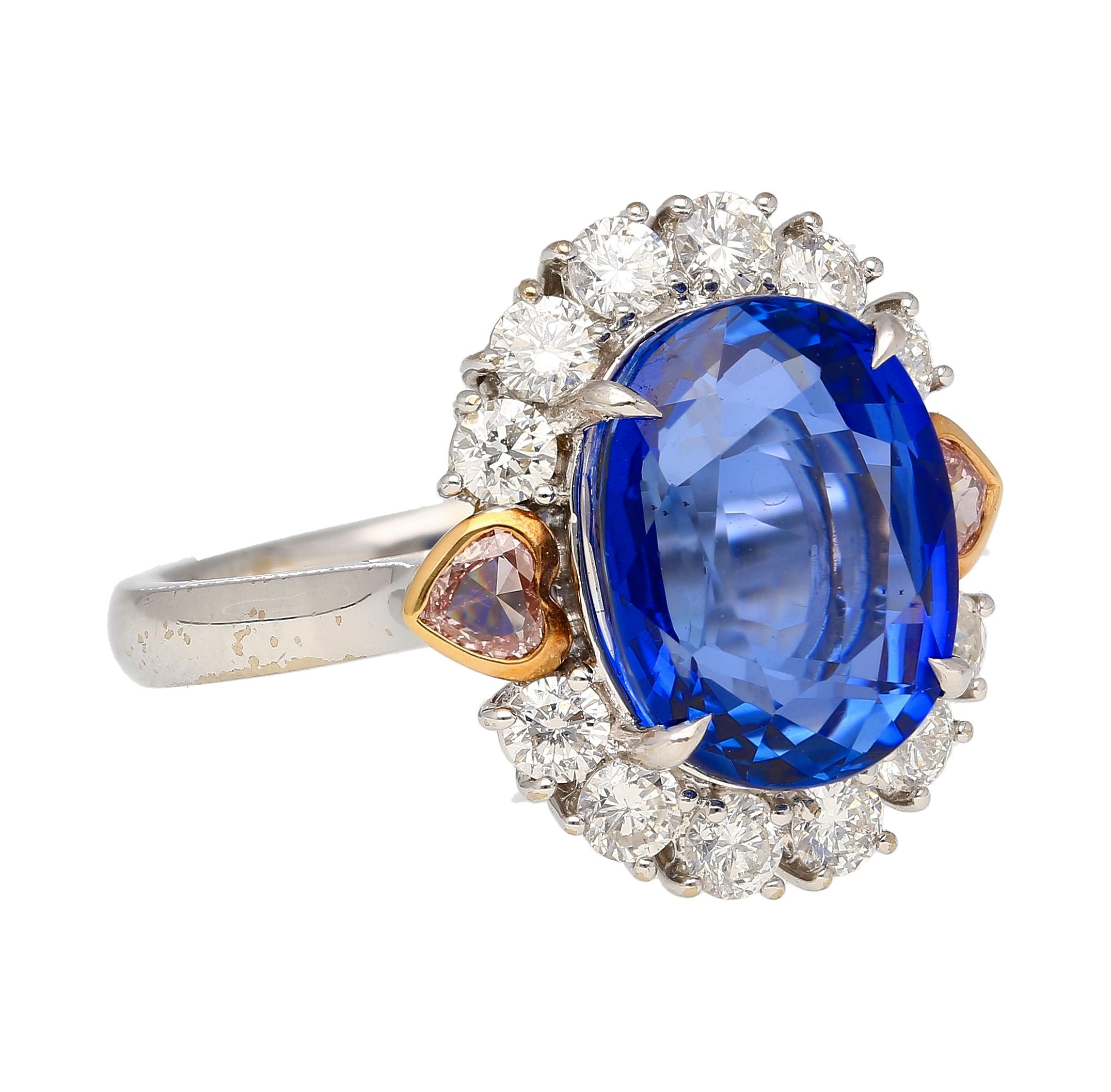 Be enchanted by the captivating beauty of this multi-stone ring, featuring a GRS certified No Heat 7.25-carat oval cut natural Blue Sapphire.

Flanked by two bezel set heart-cut pink diamonds and twelve round cut white diamonds that form a halo