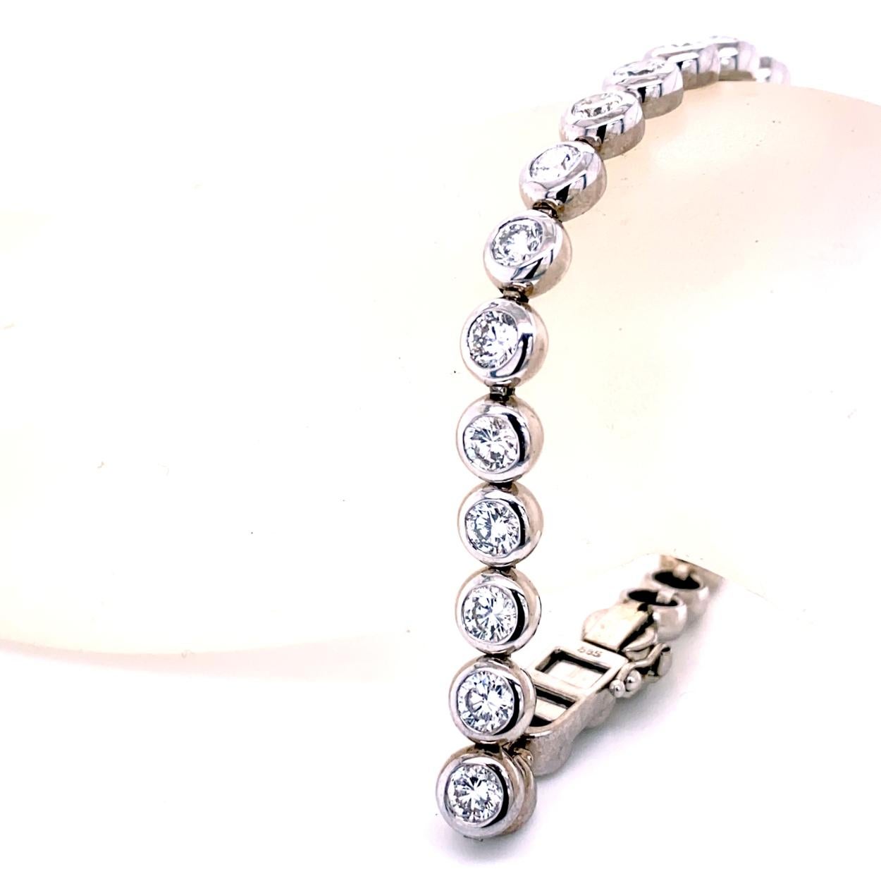 This Diamond Tennis Bracelet consists of 29 Links of Bezel Set 4mm (1/4 Ct) Round Brilliant diamonds set in 14K White Gold.   The bracelet comes with a  safety clasp to protect it from loss. 
Total Weight of diamonds: 7.25 Ct 
Total Weight of