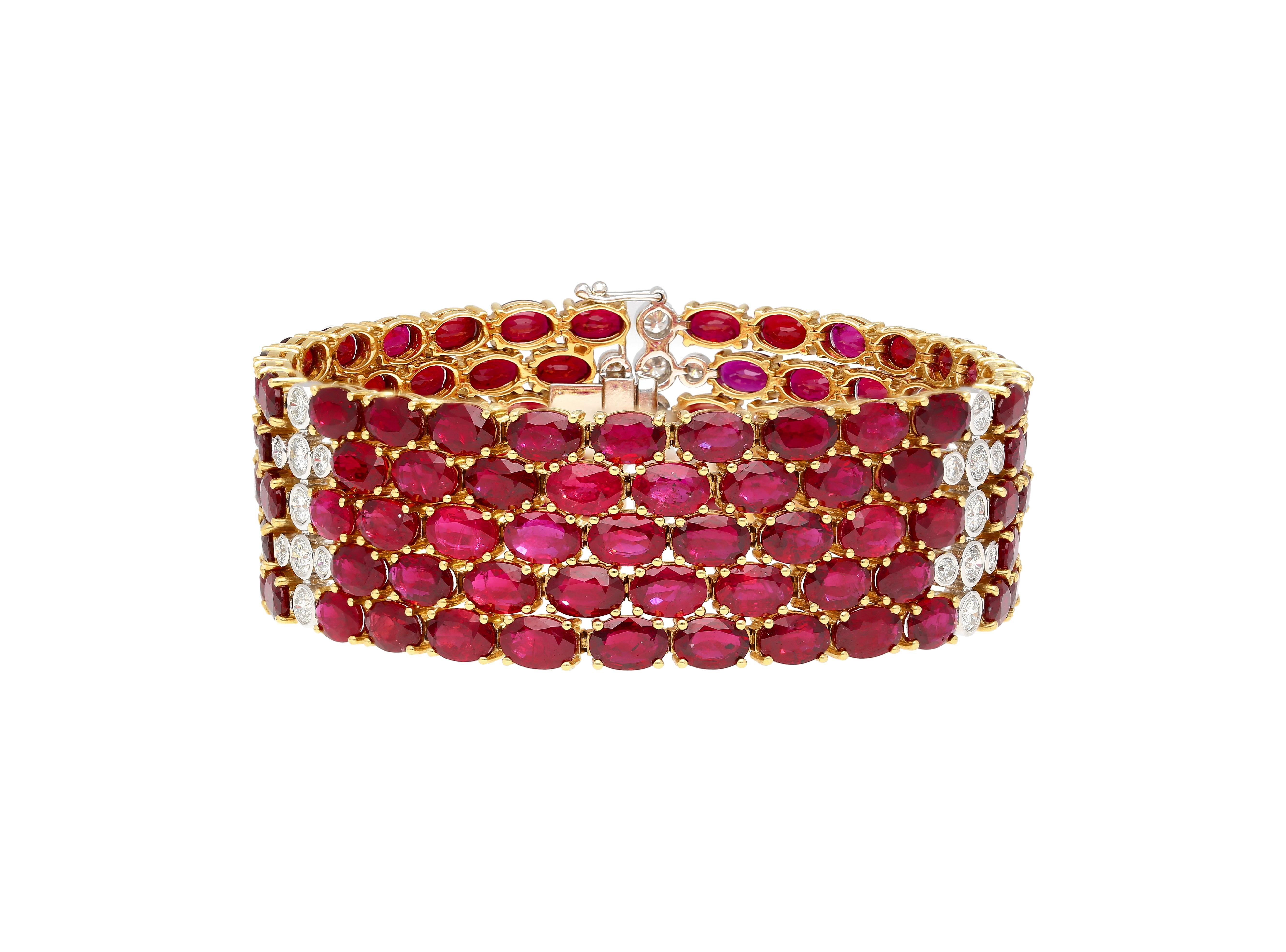18K yellow gold multi row link tennis bracelet, weighing 45.36 grams. Featuring an astounding 72.51 Carats of natural oval cut rubies, a breathtaking total of 128 stones, each radiating a deep and alluring red hue, meticulously prong-set in yellow