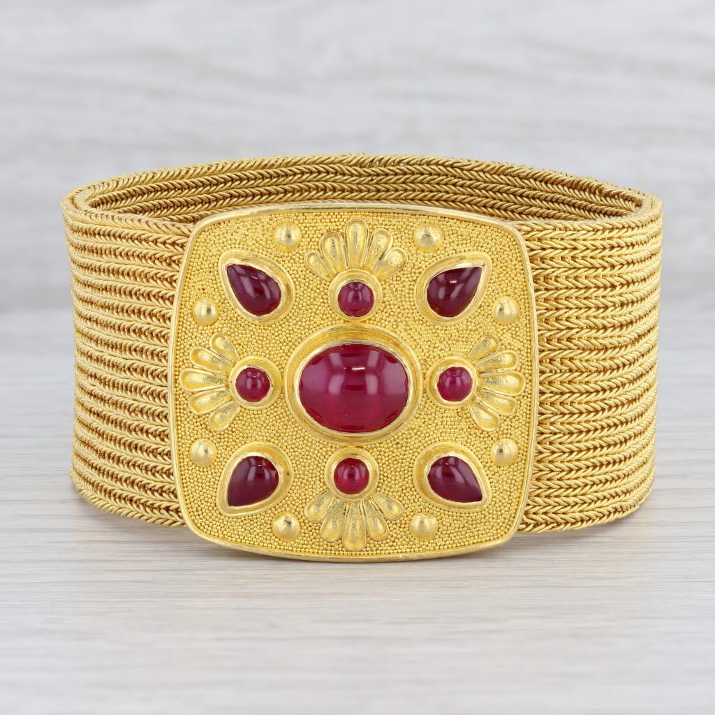Gemstone Information:
*Natural Rubies*
Total Carats - 7.25ctw
Cut - Cabochon - Oval 4ct, Round 0.85ctw, Pear 2.40ct
Color - Red
Treatment - Routinely Enhanced 

Metal: 22k Yellow Gold Bracelet, 18k Yellow Gold Clasp
Weight: 167.4 Grams 
Stamps /
