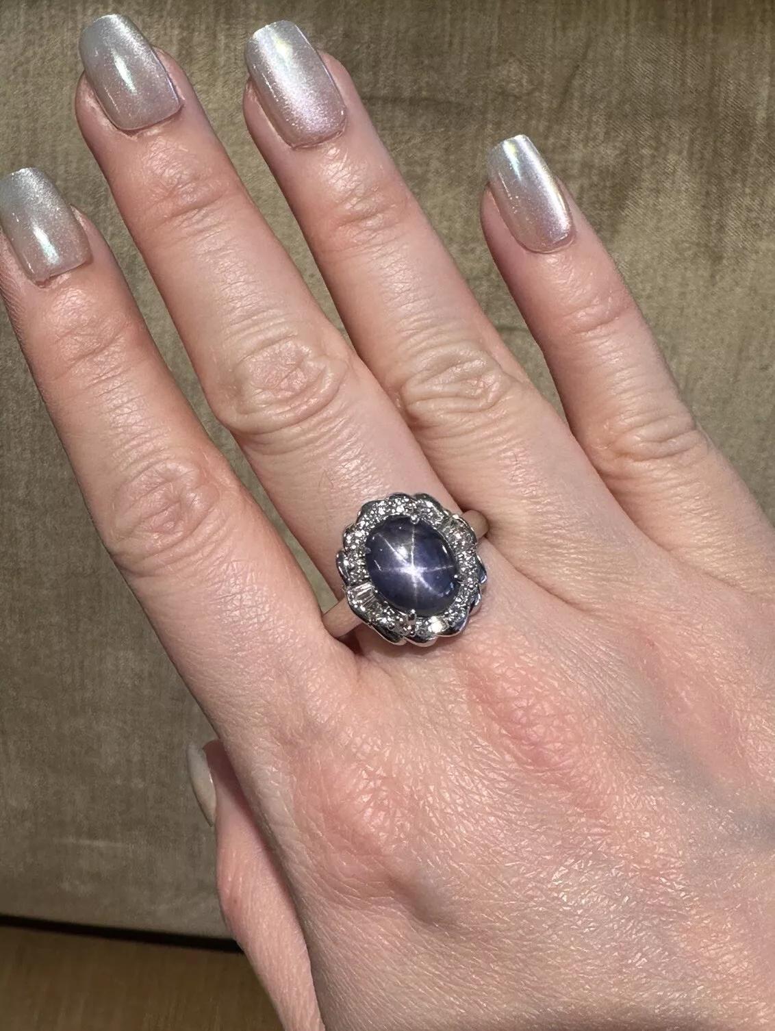 7.29 carat Natural Star Sapphire and Diamond Ring in Platinum 

Star Sapphire and Diamond Ring features a natural 7.29 carat Oval Cabochon Star Sapphire with steely blue color surrounded by natural Round and Baguette Diamonds, all set in