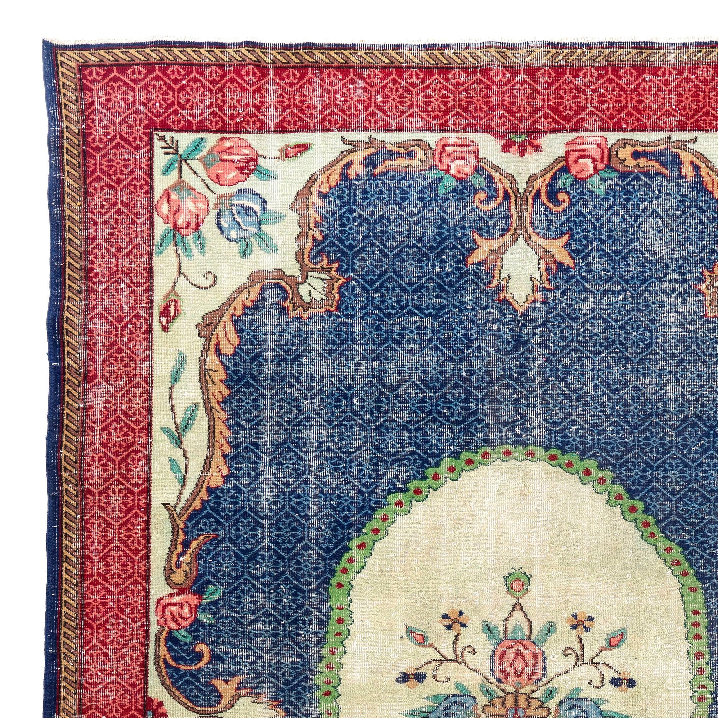 A hand-knotted vintage Turkish rug made of distressed low wool pile on finely woven cotton foundation featuring a pared down French Savonnarie style design in red, blue and cream. In very good condition. Sturdy and as clean as a brand new rug,