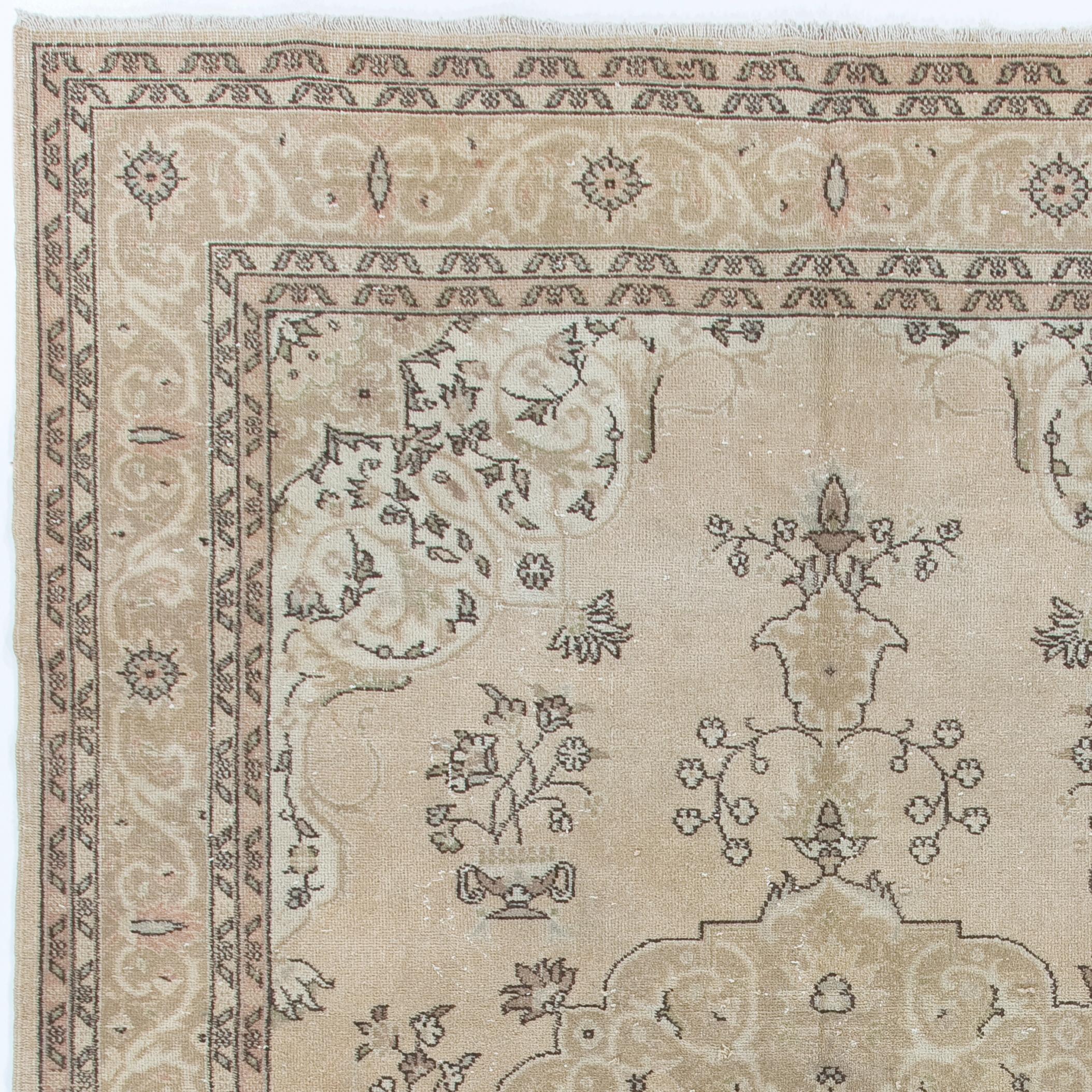 A fine, hand-knotted vintage Turkish area rug with even medium wool pile on cotton foundation. It features a well-drawn design of a central, curvilinear medallion in dark beige and off-white against a lighter, sand-colored field decorated with