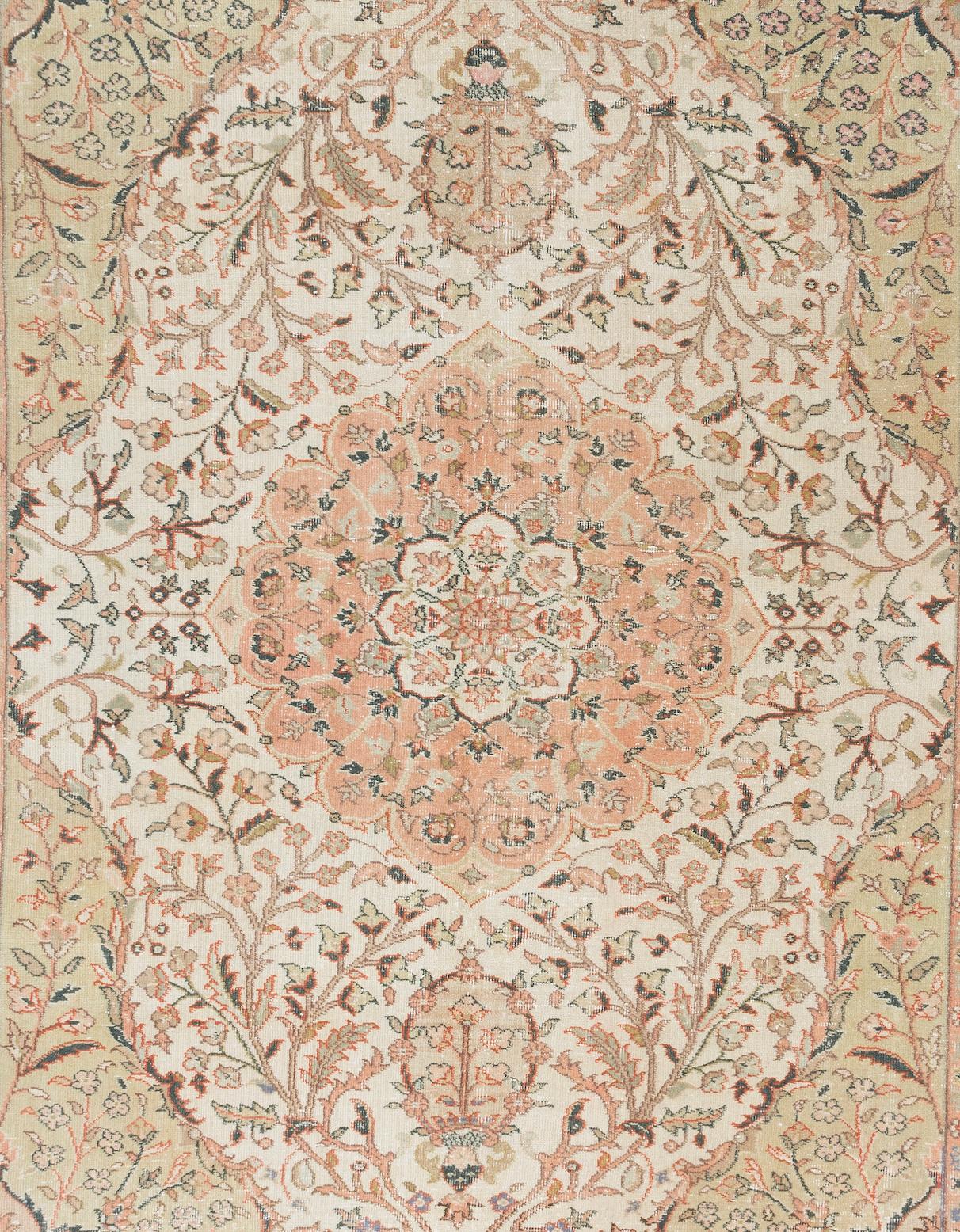 A finely hand knotted vintage Anatolian wool rug from Ladik, Konya in beautiful pastel tones of salmon pink, sand, sage green and beige. 

The centerpiece of the rug is a large, intricately-drawn medallion surrounded with floral and leafy vine
