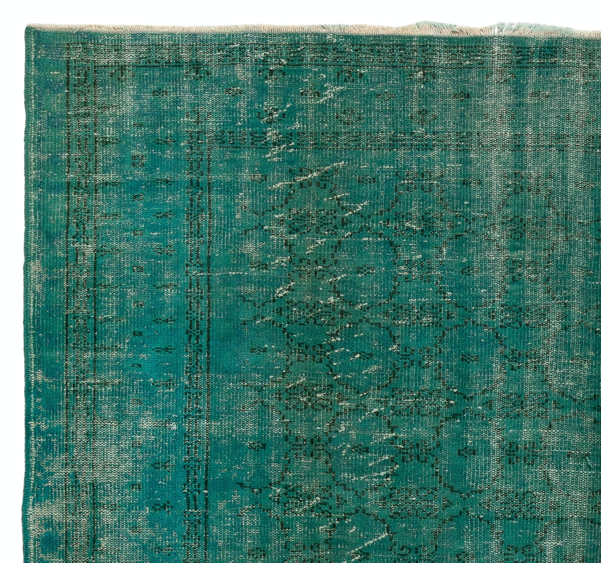 A vintage distressed Turkish area rug re-dyed in teal color for contemporary interiors. Measures: 7.2 x 9.6 ft.
Finely hand knotted, low wool pile on cotton foundation. Professionally washed.
Sturdy and can be used on a high traffic area, suitable