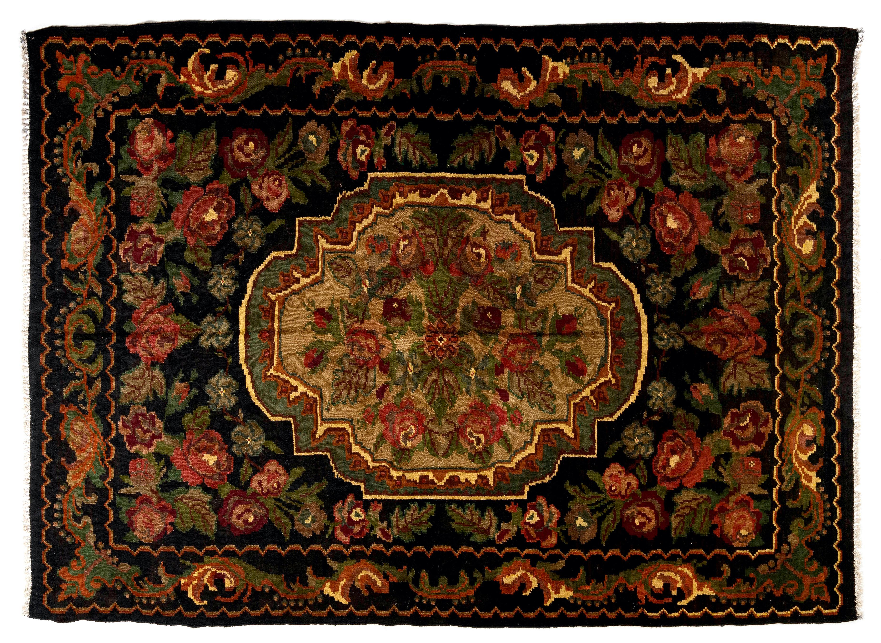 One of a kind Vintage Bessarabian Kilim. 
A hand-woven Eastern European Rug from Moldova. These traditional Moldovan flat-weaves are inspired from vintage Aubusson carpets but they are distinguished with their black grounds, large floral patterns in