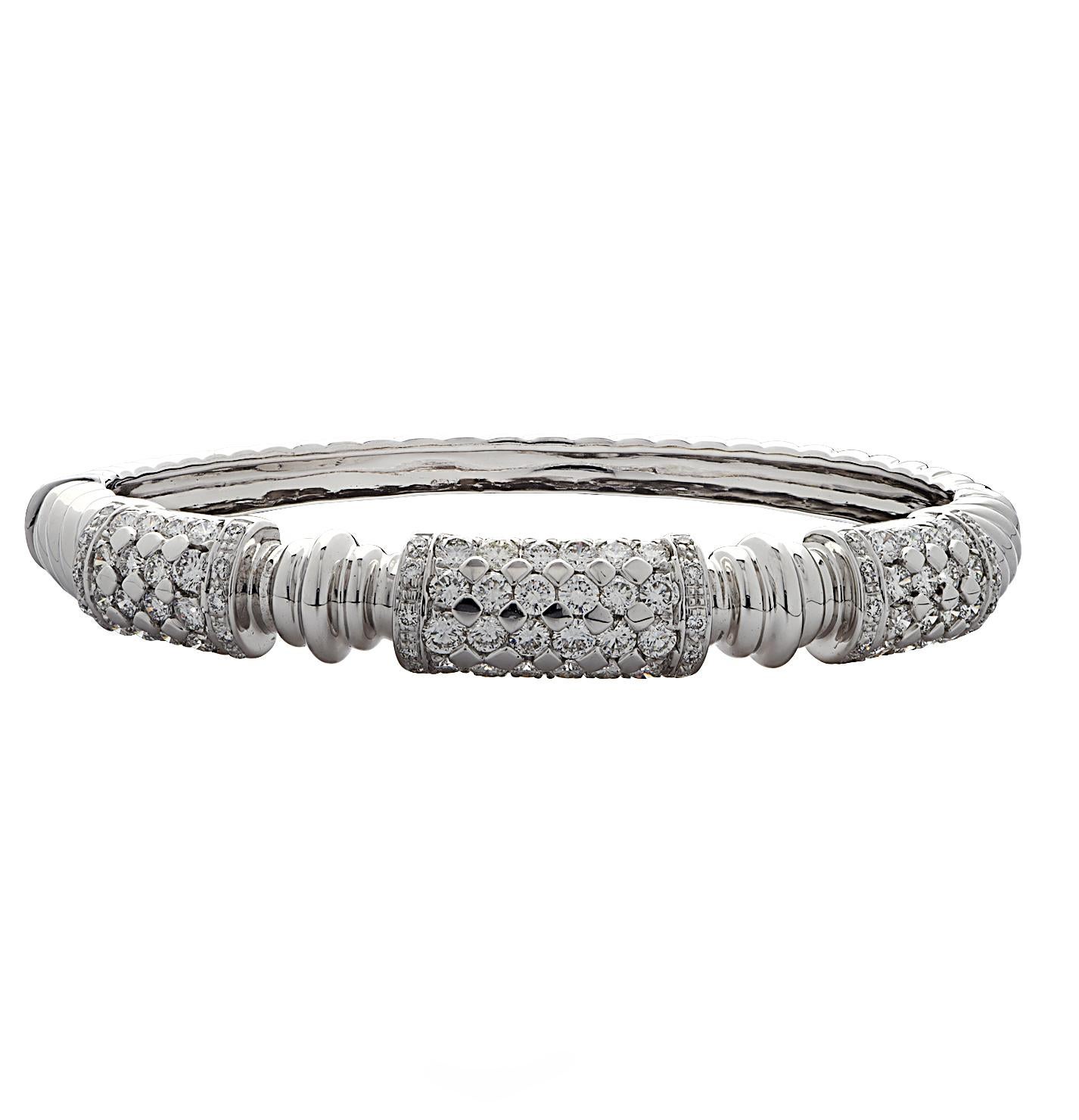 Striking diamond bangle bracelet set crafted in 18 Karat White Gold adorned with 172 round brilliant cut diamonds weighing approximately 7.3 carats total, F color, VS clarity. These stunning bracelets measure 2.2 inches x 1.9 inches and 9.4 mm at