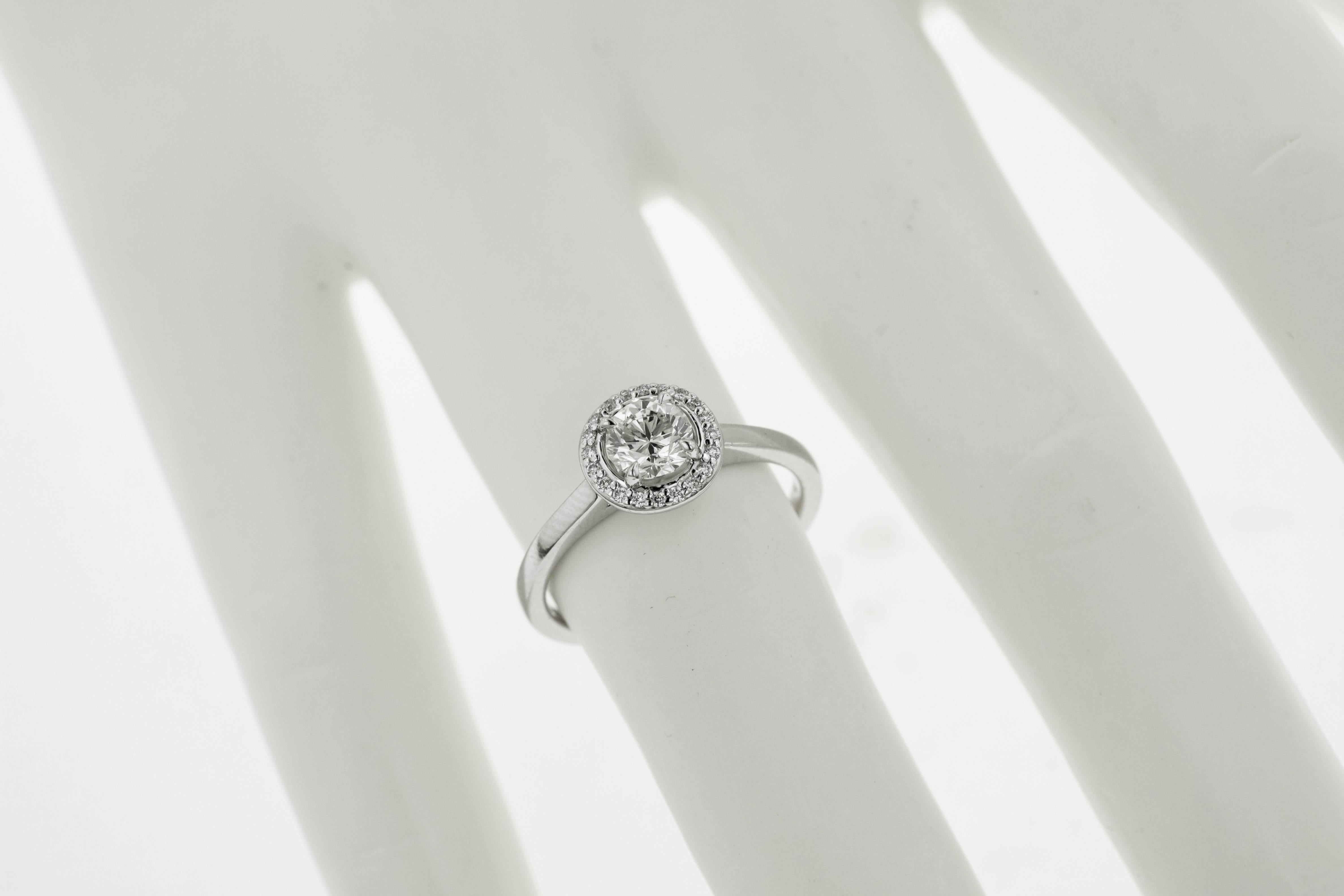Exclusive brand new engagement ring with a natural .63ct diamond center stone, encircled by a sparkling halo of .10ct diamonds. The ring is a size 7 and is complimentary resized by us for a perfect fit.

✓ Jewelry report included 
✓ Tears Undressed