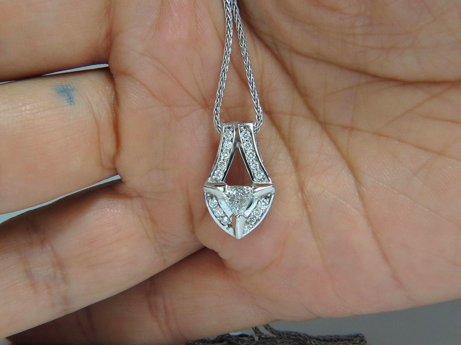 .33ct. Center Trilliant diamond pendant.

Si-1 Clarity, I-color

Brilliant cut

Side diamonds: .40ct. 

Vs-2 clarity, G-color.,

Made to look as sheild.

pendant measures: 20.26mm long

solid 14kt. white gold.

14kt. white gold weave Italian
