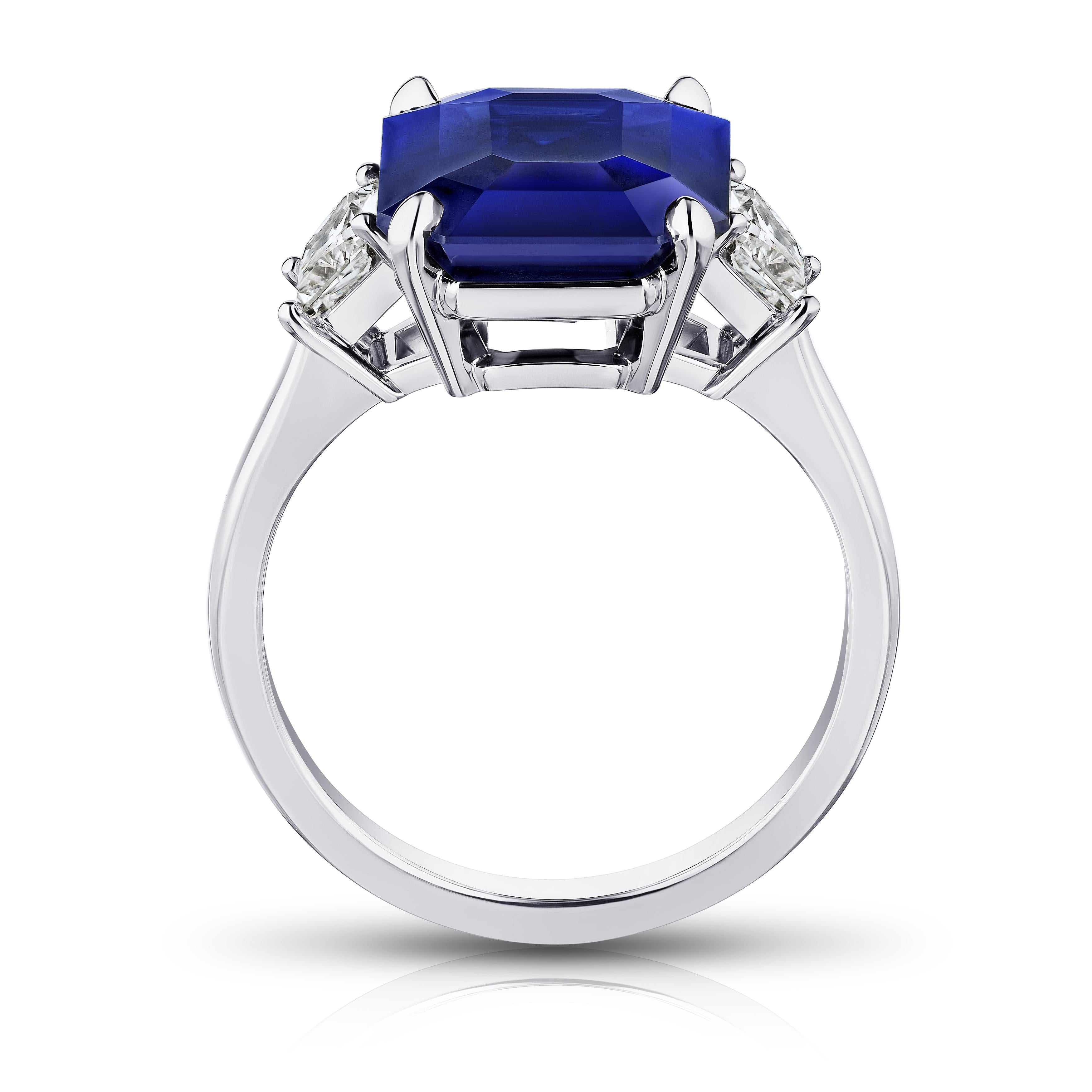 7.30 carat emerald cut blue sapphire with tapered radiant cut diamonds .79 carats set in a platinum ring. Size 7.