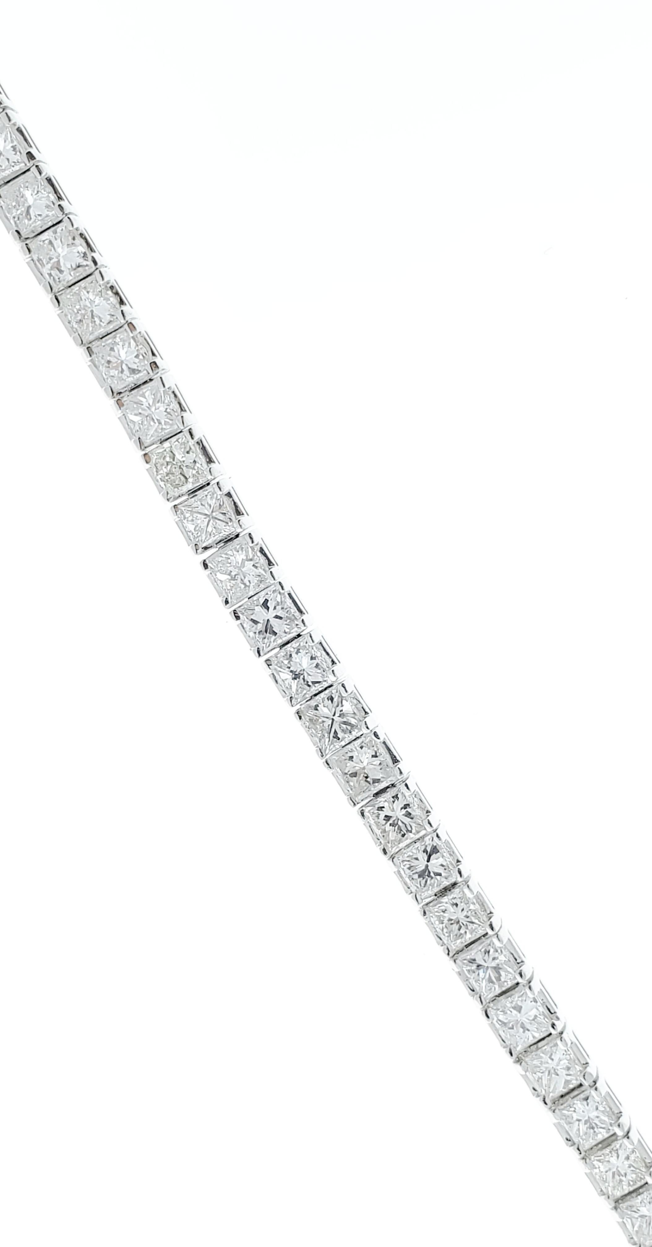 This spectacular brightly polished 14 karat white gold tennis bracelet showcases a stunning 7.30 carats of princess cut diamonds that measure 3mmx3mm each. These scintillating diamonds have a clarity of VS-SI and color G. A total of 56 diamonds are
