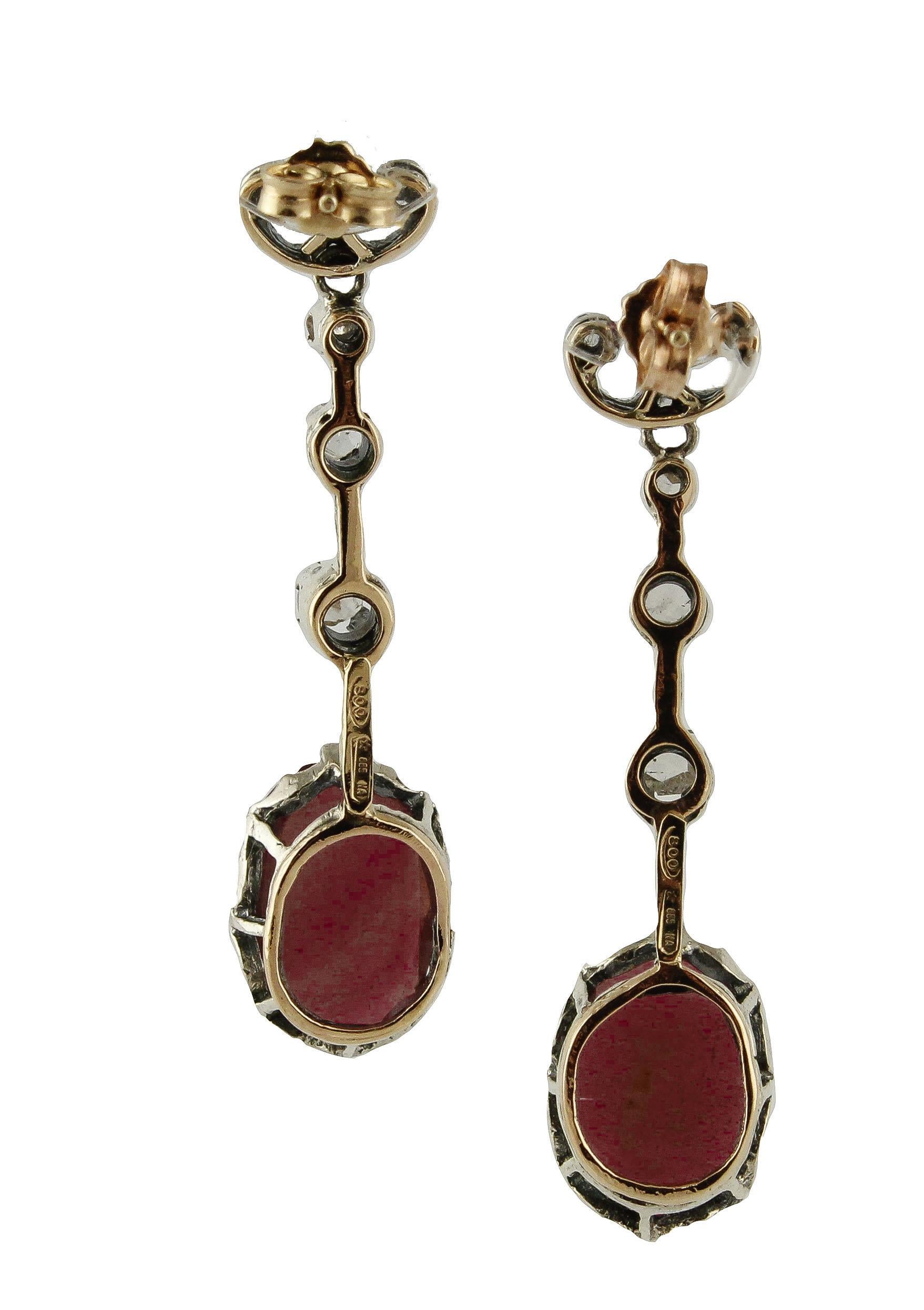 Refine and elegant dangle earrings in 9K rose gold and silver structure composed of 7.30 ct of deep color big rubies and a sequence of three shining rose cut diamonds 
Diamonds 0.50 ct 
Rubies 7.30 ct / 14 mm X 9 mm
Total Weight 6.90 g 
R.F *