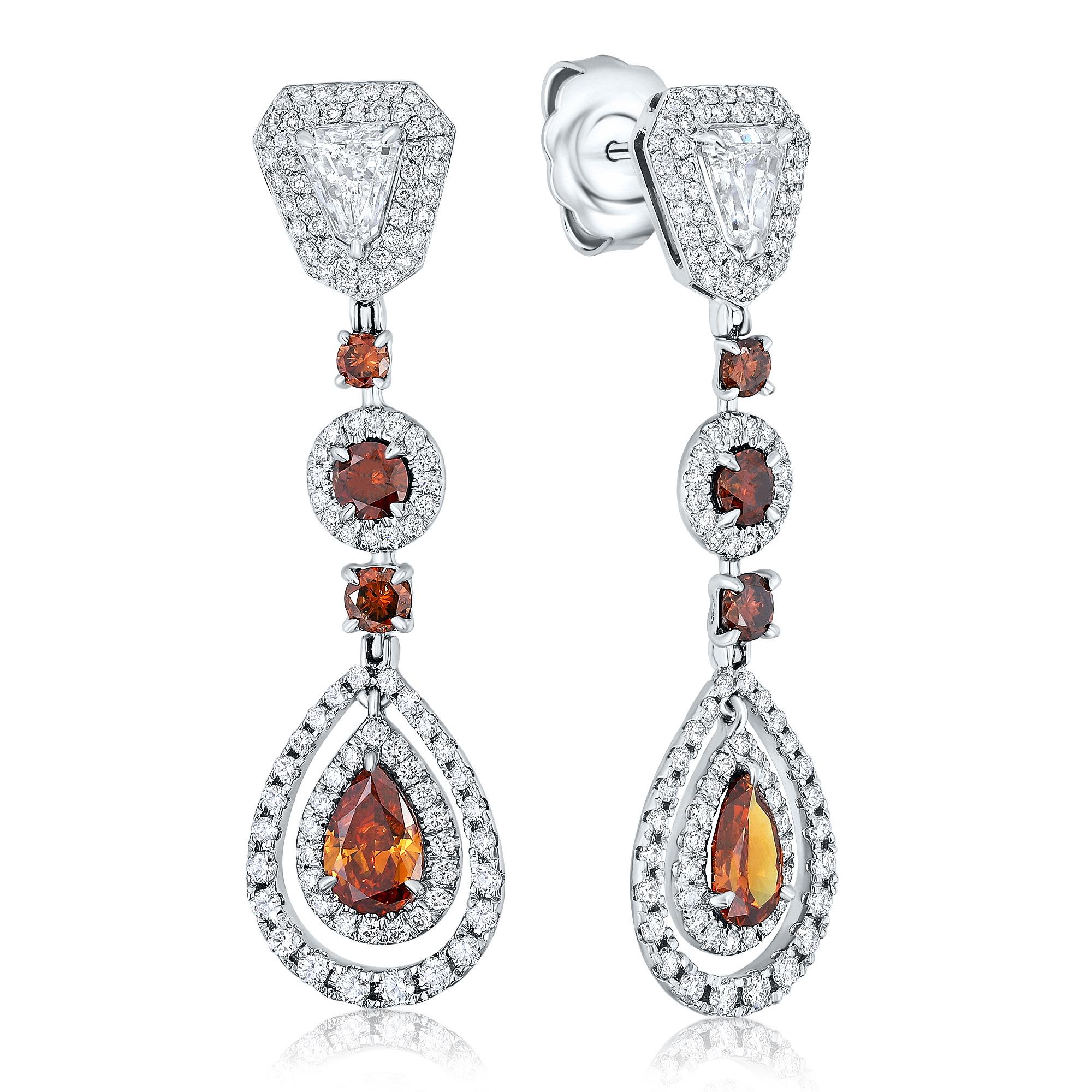 Introducing a stunning pair of teardrop diamond earrings that are sure to make a statement. These earrings feature a vibrant mix of eight brown diamonds, weighing approximately 2.32 carats, along with two shield-cut white diamonds weighing 1.21
