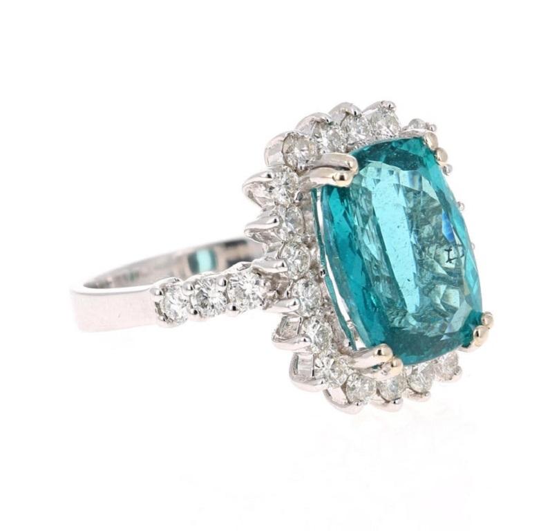 Classic and beautifully designed Apatite and Diamond Ring! This ring has a 6.24 Carat Oval-Cushion Cut Apatite and is surrounded by 26 Round Cut Diamonds that weigh a total of 1.08 carats. The clarity and color is VS/H. The total carat weight of the