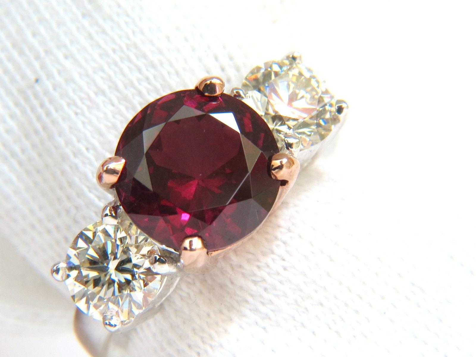 5.13ct. Natural Rubellite three stone ring.

10.20mm diameter

Transparent & Clean clarity.

Vibrant red tone.

Fully faceted, cut like diamond.



Side Round, full cut diamonds:

2.20ct. 

J colors, Si-1 clarity.



14kt. white gold.

8.7