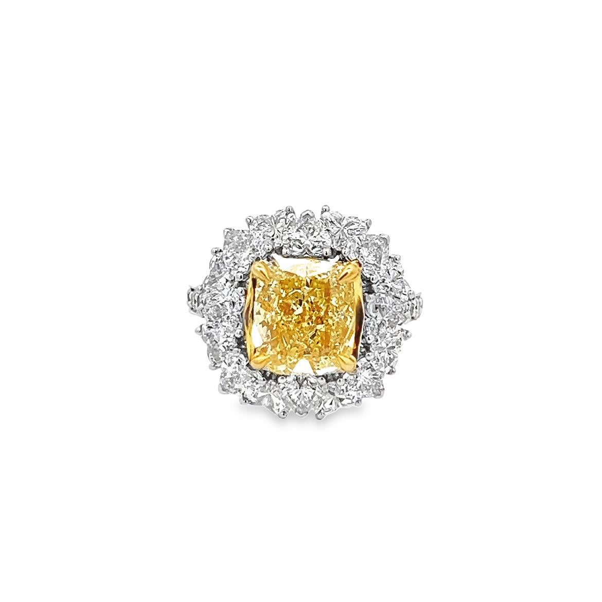 This exceptional 3.63ct cushion-modified brilliant, natural fancy yellow even, clarity SI1 GIA certified diamond ring is a true masterpiece. Its handmade design and 18k yellow gold setting make it a truly remarkable piece of jewelry that is sure to