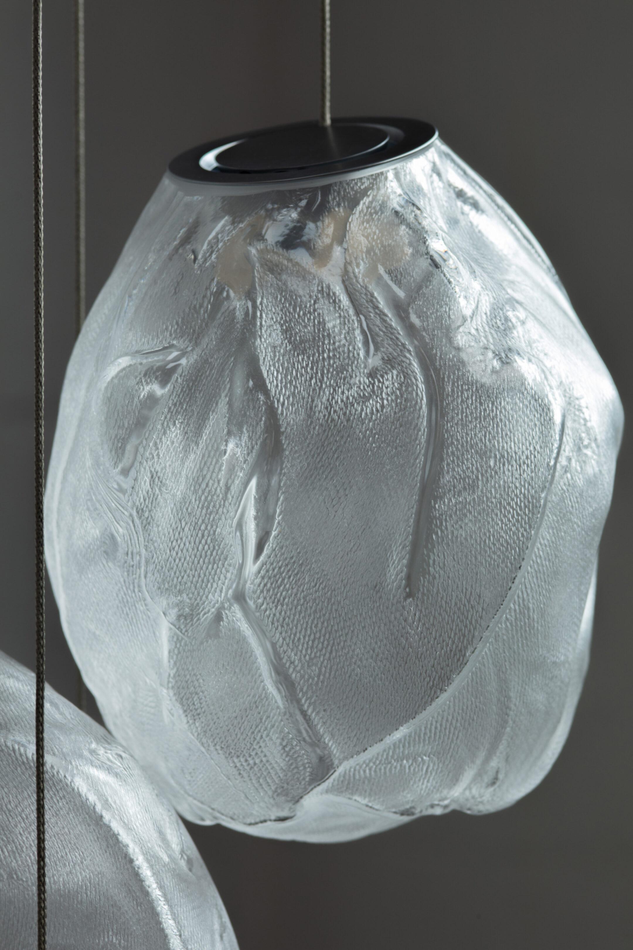 73.3V Random / Chandelier 
by Omer Arbel

73V is an expansion of the technique used to create Bocci’s popular 73 series. The new pendant features a novel oblong shape and gradient color range. 73V results from blowing molten glass into a folded,