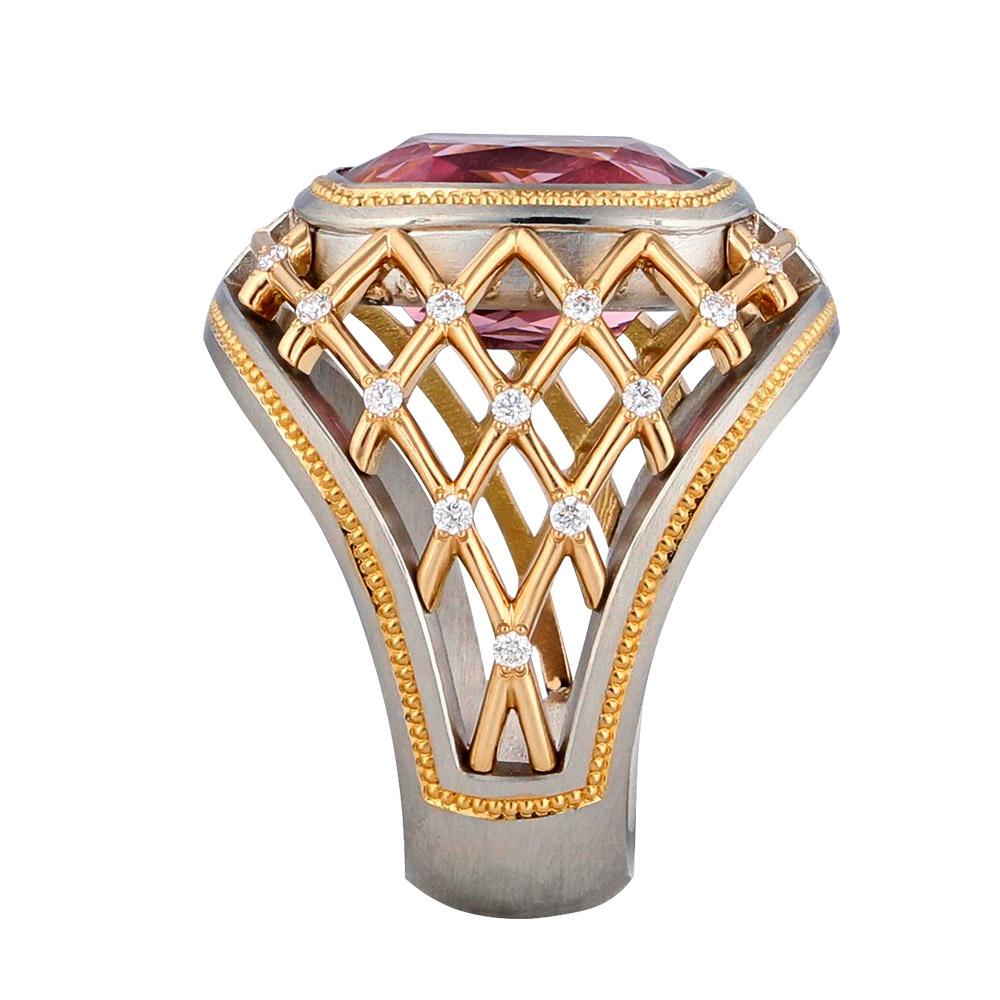 One of a kind 7.34 ct. Lotus Garnet set in Platinum with 22K Rose Gold hand engraved shaped inlay and Rose Gold grill. Accented with twenty-four .01 ct. round brilliant Diamonds. 20 mm across the top of the ring and 7mm wide at the bottom of the