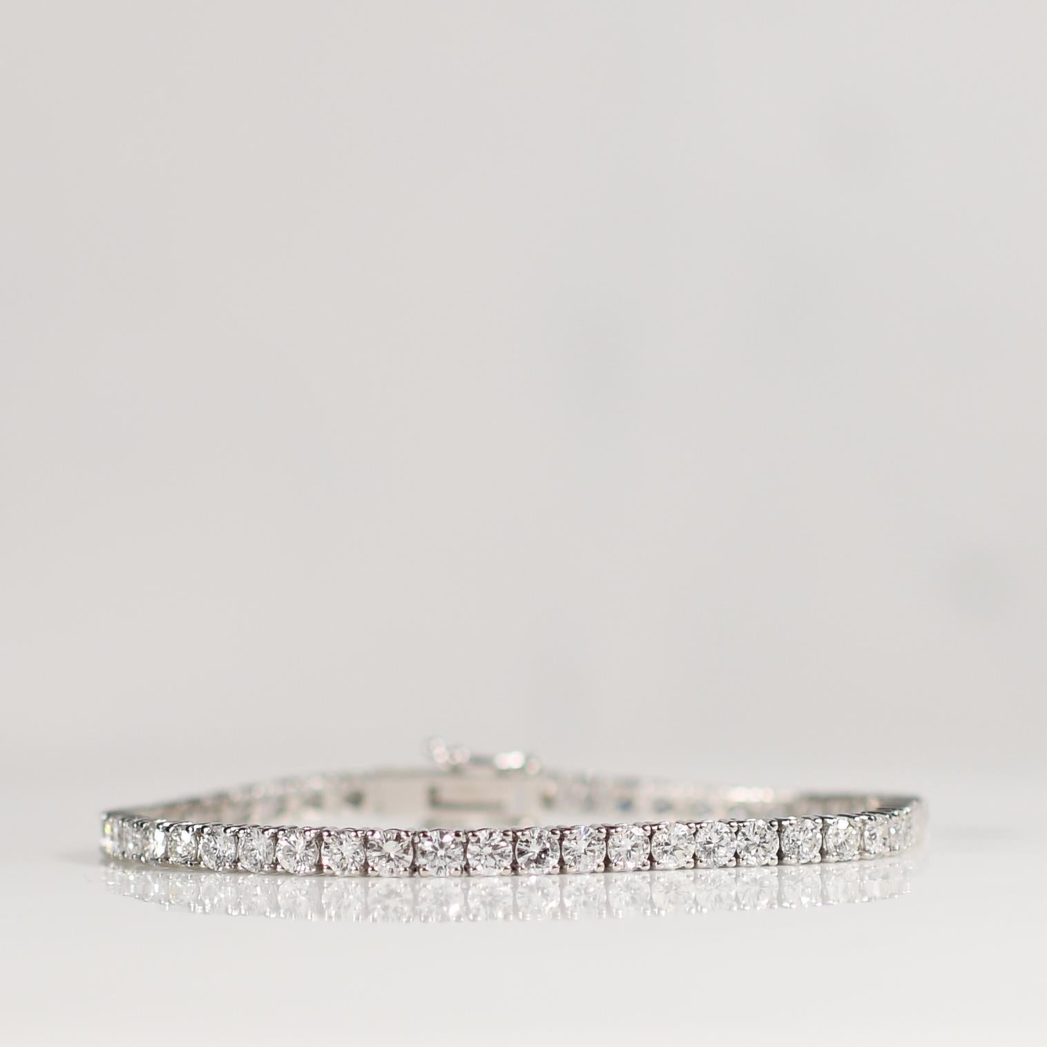 Make a stunning statement with this exquisite 7.34 carat total weight round brilliant cut diamond tennis bracelet, elegantly set in gleaming 14k white gold. Featuring 51 dazzling diamonds, each expertly crafted to maximize brilliance and fire, this
