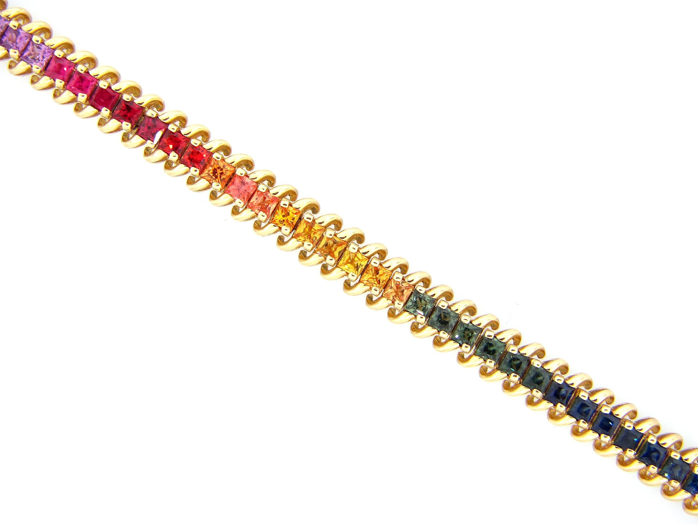 This stunning Rainbow Sapphire Bracelet features the full spectrum of Princess Cut Rainbow Sapphires 
This Bracelet is set in 14K Yellow Gold —  is 7 inches in length and is secured with a box clasp.
Total Sapphire Weight = 7.35 Carats.
