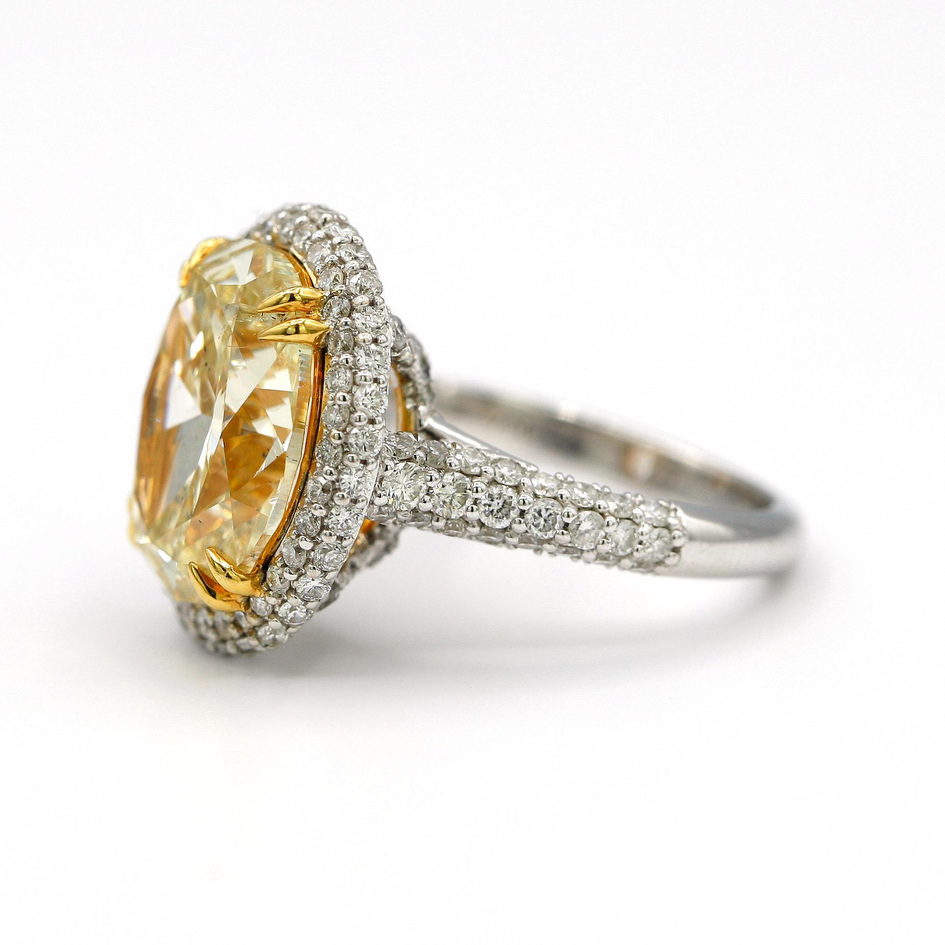 This marvelous ring has a center stone of 7.36 Carat EGL Certified Fancy Light Yellow Oval SI2, along with 1.48 Carat Pave Diamonds placed along the border of the center stone.
Mounted in 18K White Gold.
Ring Size 6